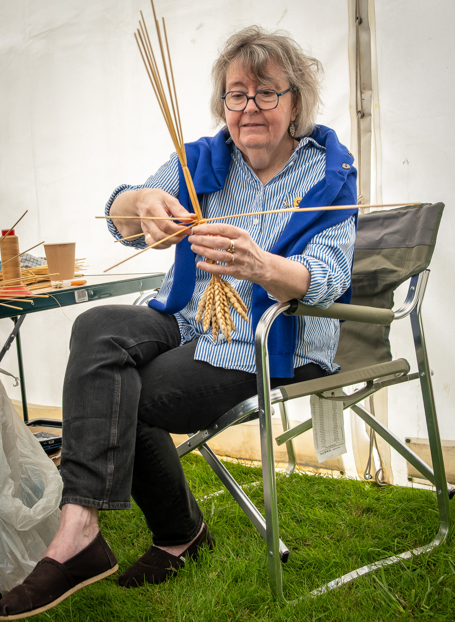 Caroline, the Wheat Weaver who uses traditional craft techniques from the dying art of corn dolly making to more modern creations and elaborate installations as well as film and theatre props.  Migg Kimpton's Summer Fete at Little Mongeham, near Deal, 2nd August, 2025.
