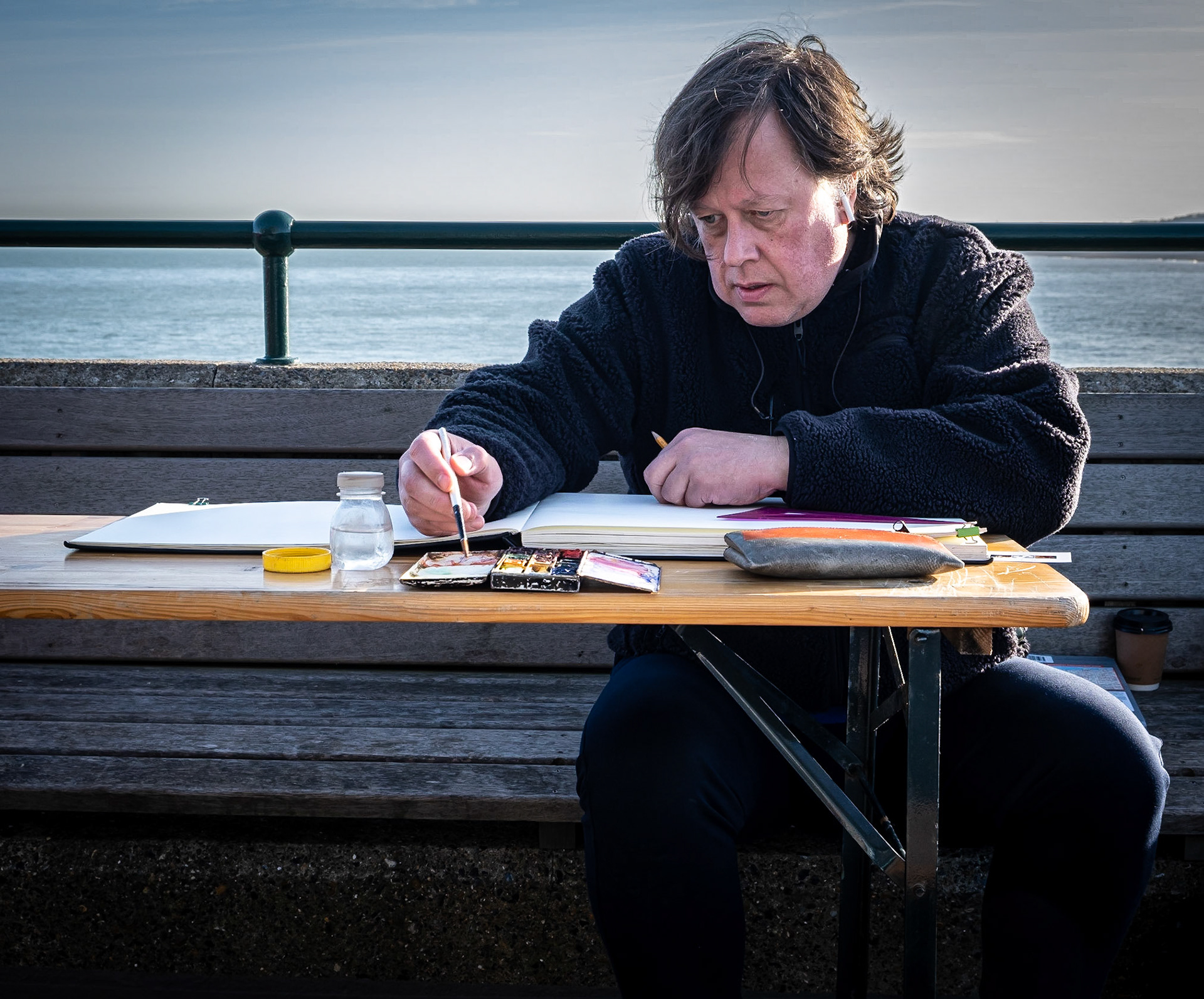 Benedict, an Architect down from London, sketching and painting on the end of the Pier. 
