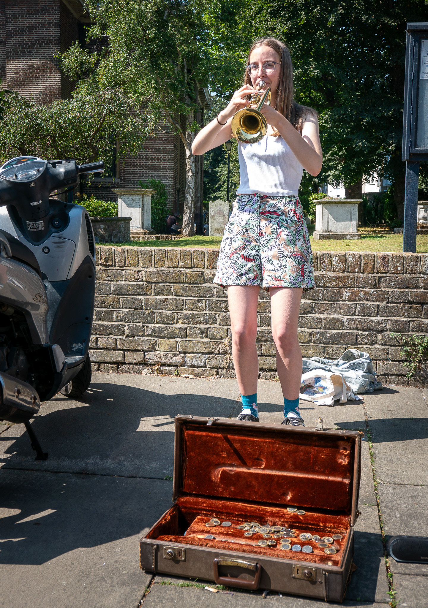 Ellie, a trumpeter, busking outside St Georges Church, Saturday, 17th August, 2024.