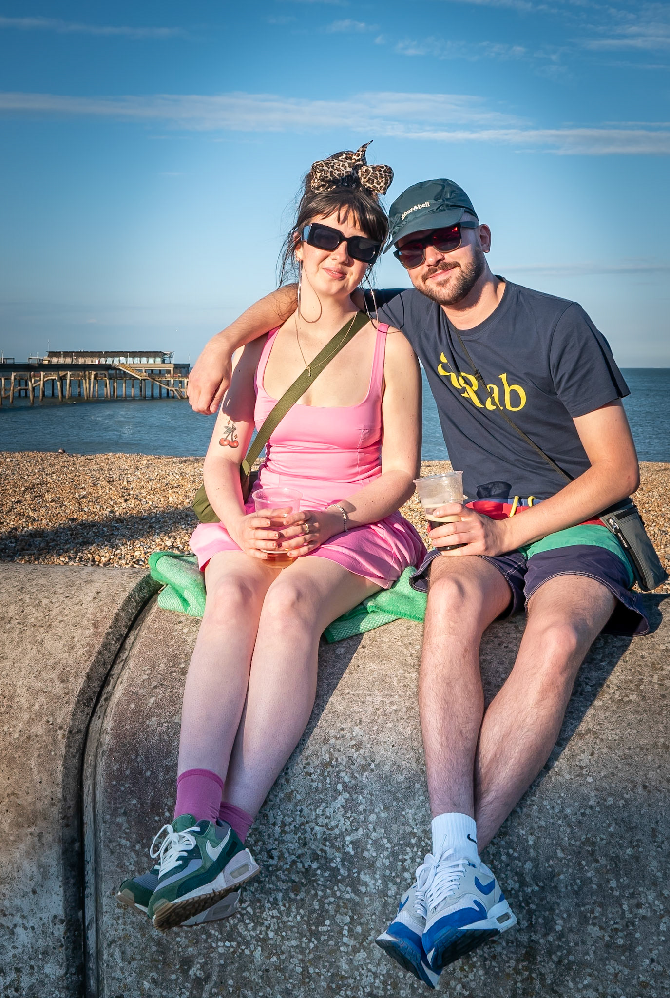 Celia and Billy. Celia works at Pho, a Vietnamese restaurant in Canterbury. Billy is a steel cutter in Sheffield and said that he was visiting his 'prize' girl in Deal. I said, look after her Billy. Celia said, "Yeah, my glass is nearly empty". Deal Seafront, 22nd June, 2024.
