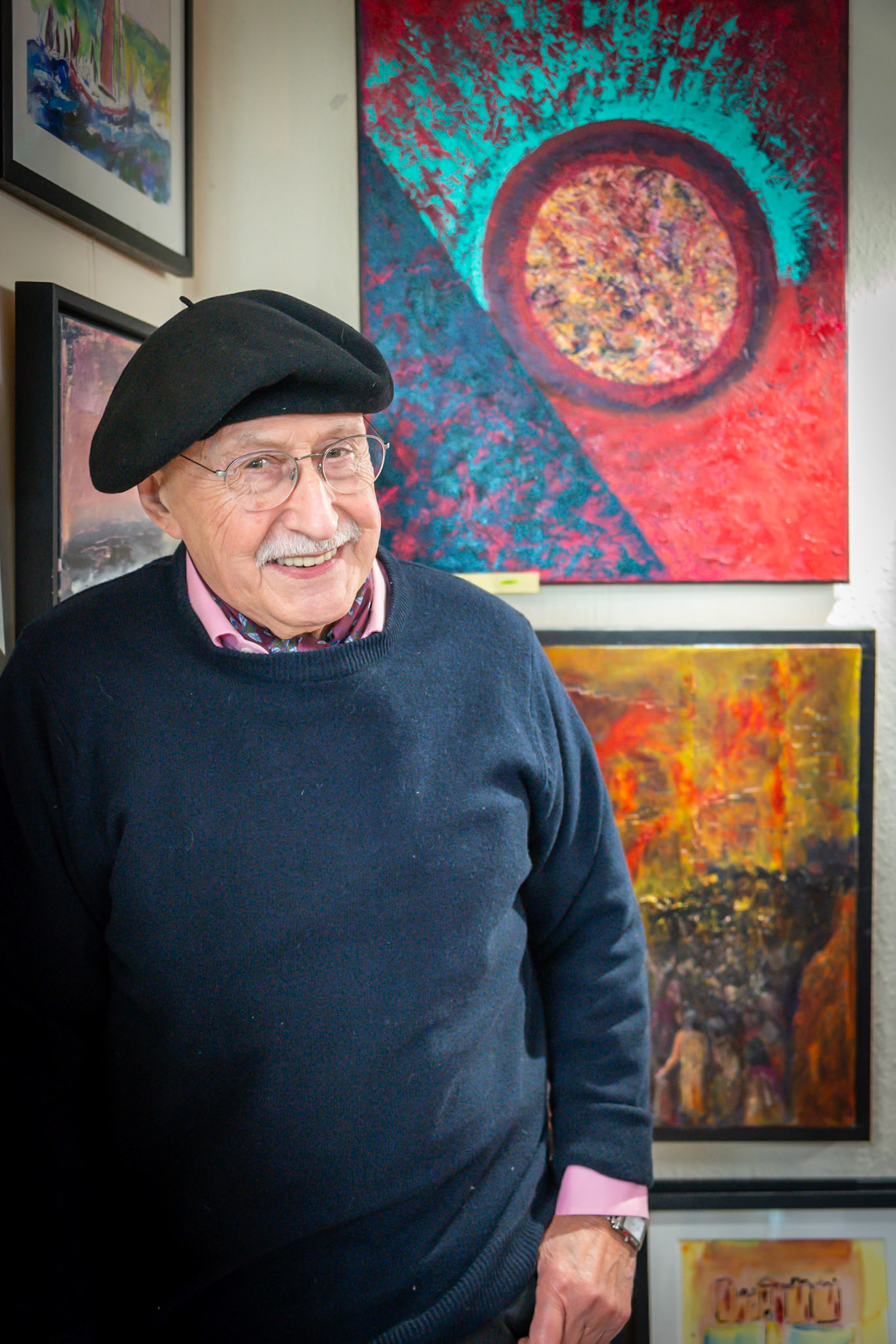 Bill Cameron-Ward with a few of his paintings at Penny Bearman's drinks party, Sea Lark Studio, 13th December, 2024. Bill  was previously in charge of advertising at the International Herald Tribute and the Economist in France. He lived in Paris for 30 years.