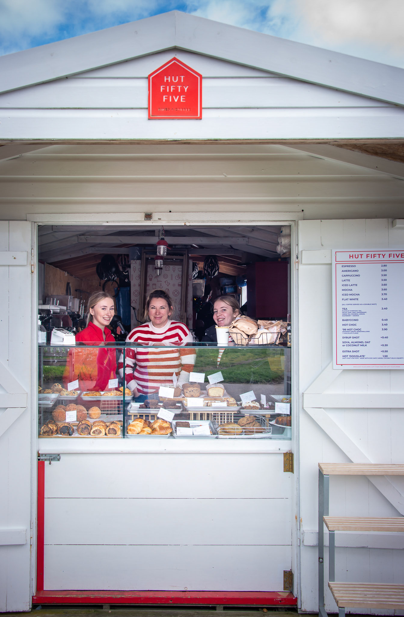 Poppy, Kate and Eliza serving at Hut 55. First day of opening after the winter break: 29th March 2024. Hut 55 provides great food and drinks for passers by, rents out bikes and supports cyclists on Sustrans Route 1 which runs along the seafront. Hut 55 is so named as it is located on the section of Walmer Beach where Julius Caesar and two Roman Legions (between 10,000 and 12,000 soldiers) landed in 55BC.
