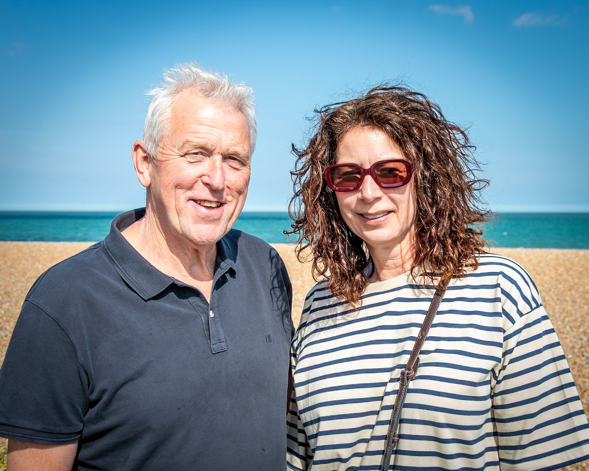 Stuart and Colleen enjoying a stroll in the sun at the Deal Food Festival, 2nd May, 2025. Stuart is a cameraman and photographer at the BBC. Colleen originally hails from a farming community near Rotarua in New Zealand. They have a house in Deal. 