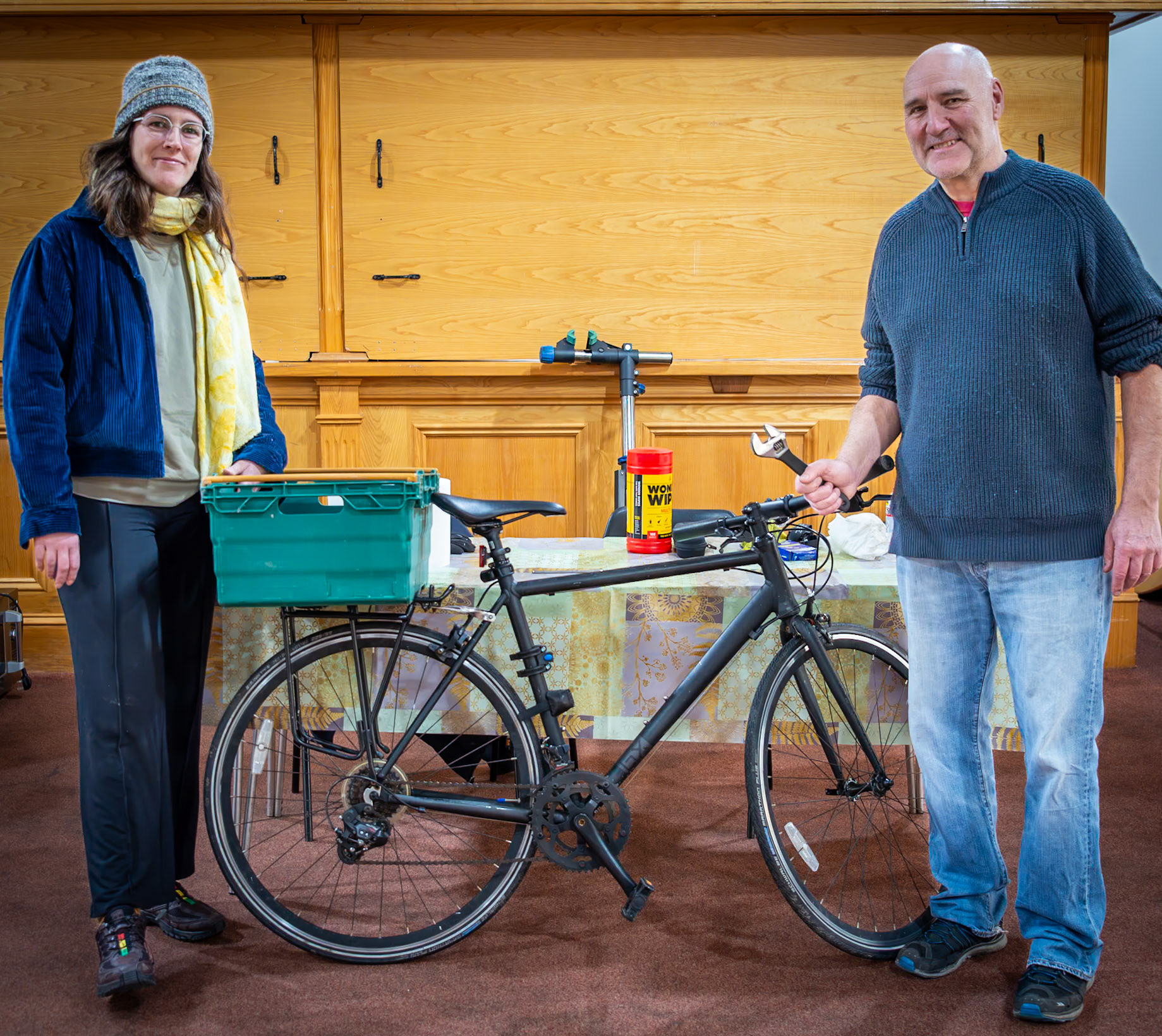 Phoebe, a decorator, having her bike repaired by Tony, a Health and Safety Trainer, The Repair Cafe, Landmark Centre, Deal High Street, Saturday, 13th January, 2024.