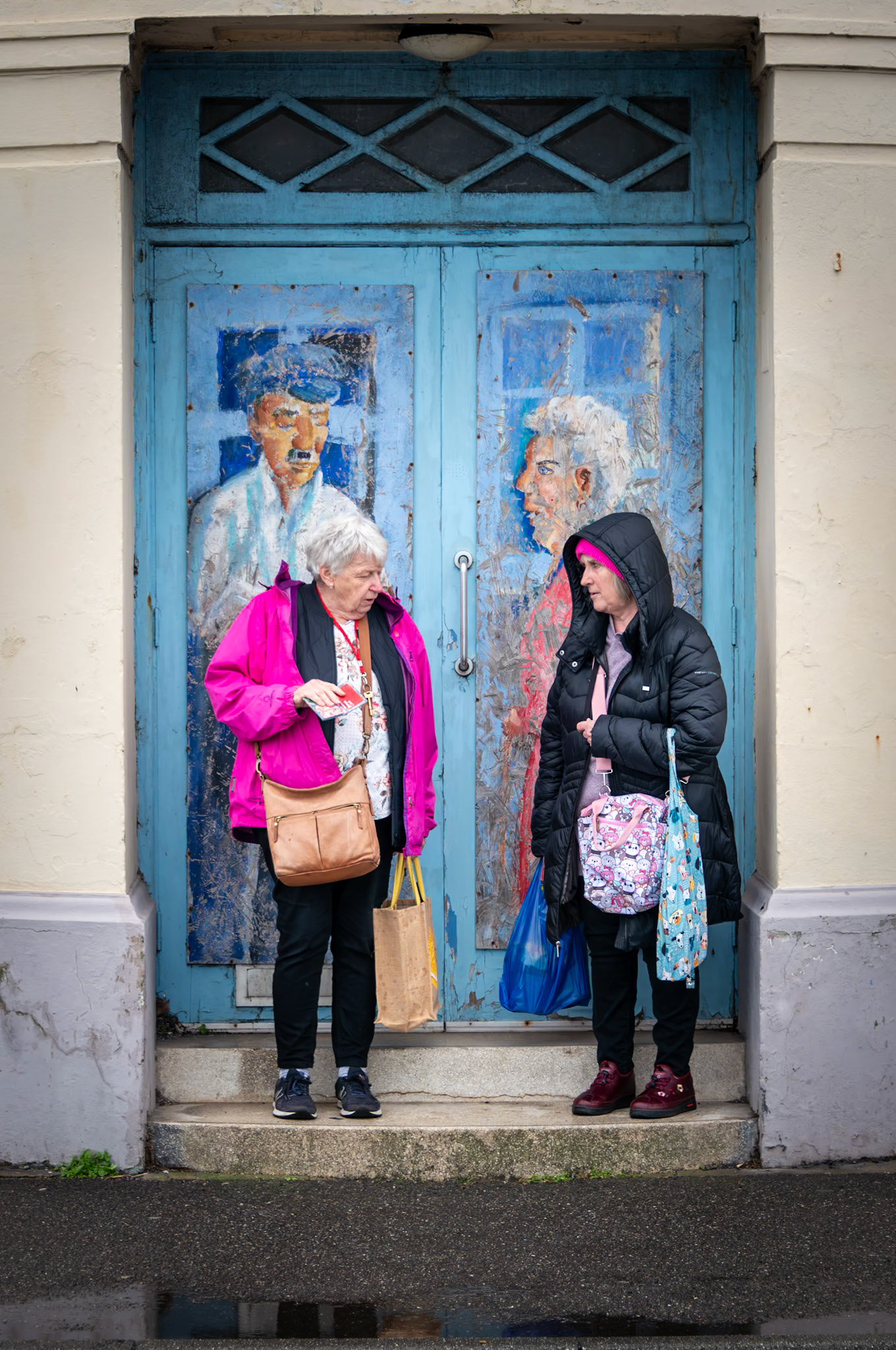 Carol and Angie waiting for the number 12 bus to Walmer. They have lived in Walmer for 76 years. The Old Regent Cinema, Beach Street., 24th February, 2024.