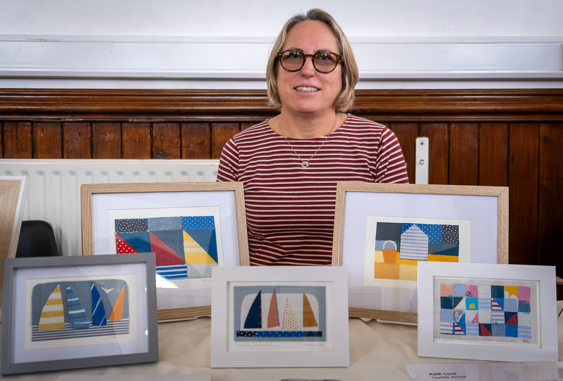 Kath Love a textile artist showing her hand embroided textile artworks at the Annual Postcard Art Show, The Landmark Centre, 18th November, 2025. Kath uses hand embroidery and a combination of patchwork and applique techniques to create her pictures capturing life at the coast. www.kathlove.com 