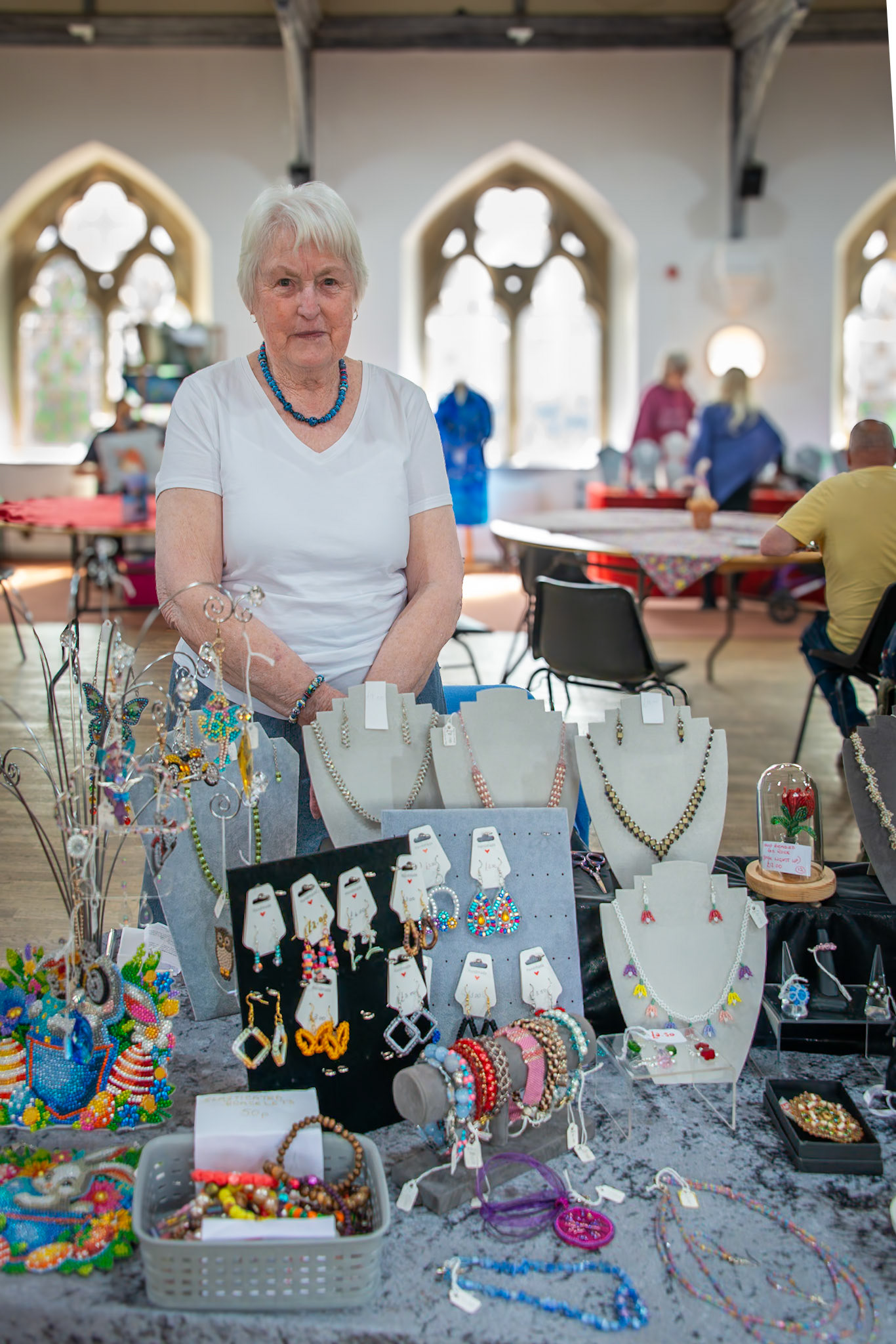 Josephine who makes beaded art jewellery.  Craft Fair for the Leaps and Bounds Community Project, The Landmark Centre, 12th April, 2025. The project promotes independence and provides skills for adults with learning disabilities.