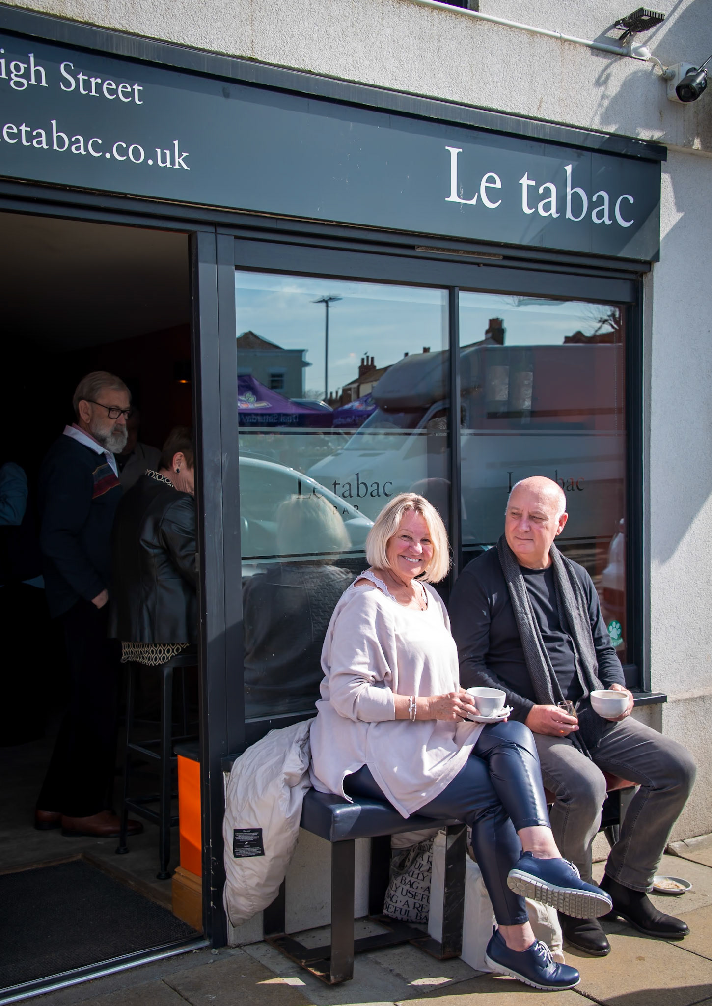 Hazel and Tony having coffee and armagnac outside Le Tabac, Deal High Street, 16th March, 2024. Hazel works for British Airways on long haul flights. Tony is a Managing Director.