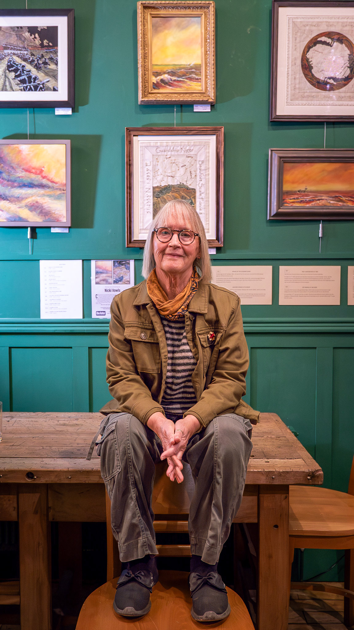 Nicki Vowls exhibiting at the South Eeast Artists' Exhibition Bar, Astor Theatre, 3rd December, 2025. Nicki is best known for her linocuts and oil paintings featuring local seafaring heroes. depicting ferocious sea conditions and the opposing moods of desolation and hope - always hope .... Nicki is one of SEAS original members and has regularly exhibited in Open Studios. Her work has been exhibited at the Royal Academy Summer Exhibition, the Turner Contemporary Open Show, Linden Hall group shows and the Royal Society of Printmakers at the Bankside Gallery, London.