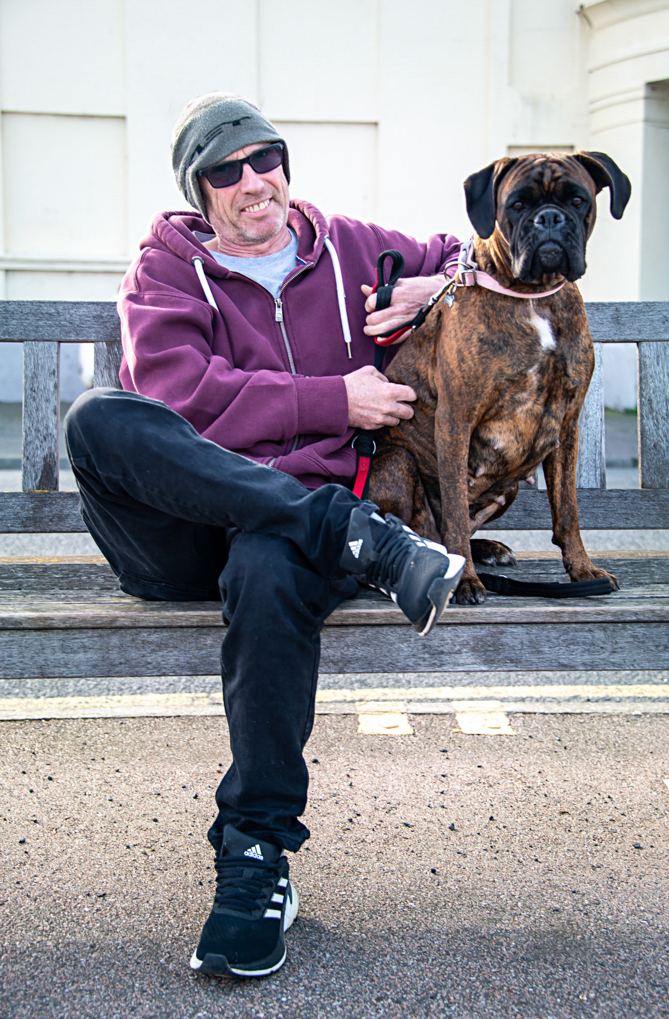 Paul, a Plumber's Mate and his boxer Laila, named after Muhammad Ali's daughter. Apparently, many boxer dogs are named after pugilists. Beach Street, 20th March, 2024.