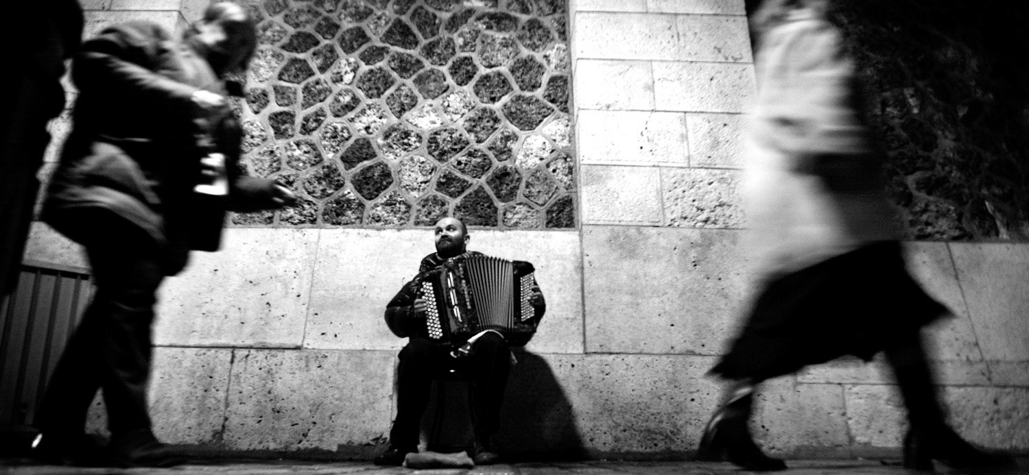 A Parisian accordionist busks for money next to Sacre Coeur in Montmartre on Christmas Eve.
