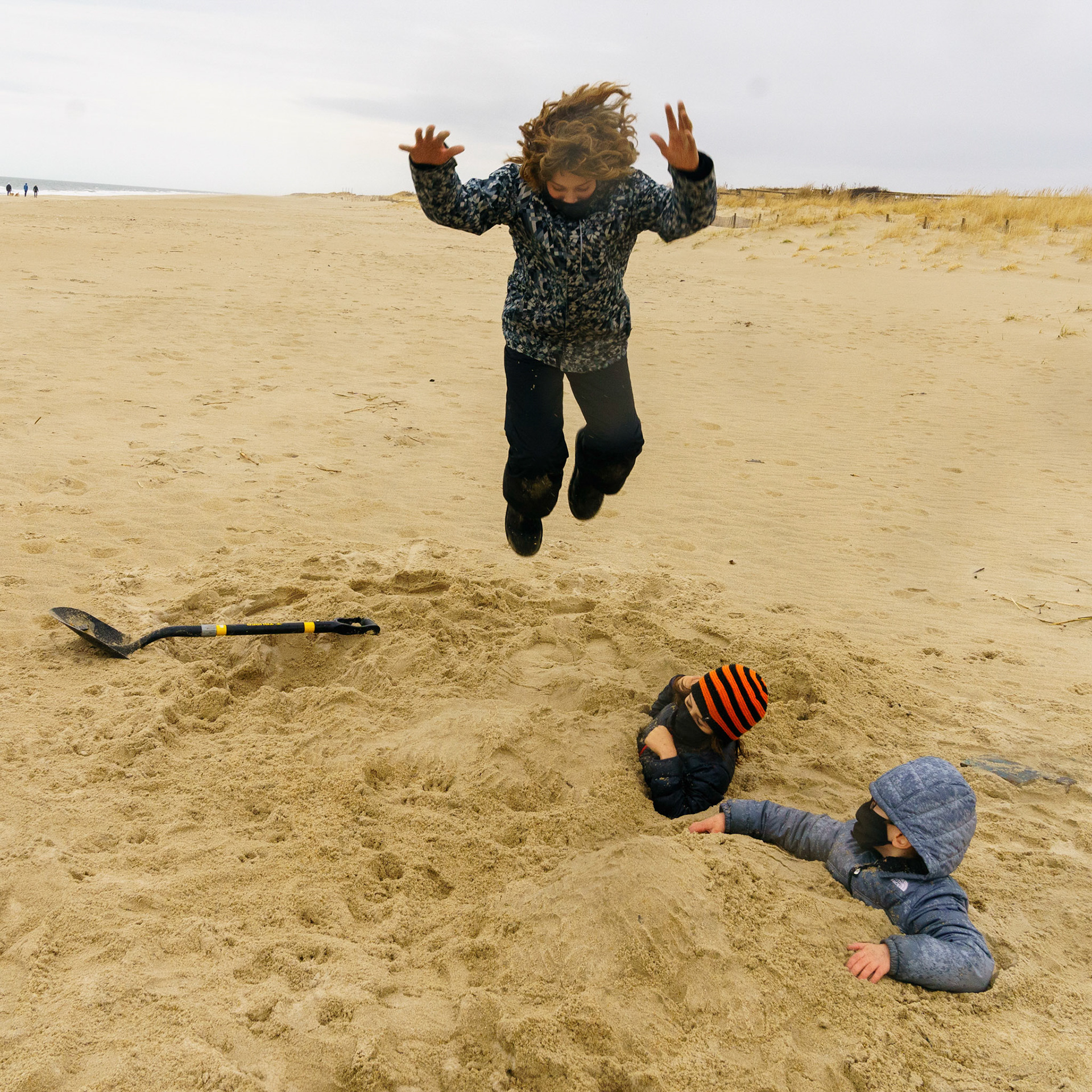 New Year’s trip to the beach. Playing at the beach. Buried little ones.