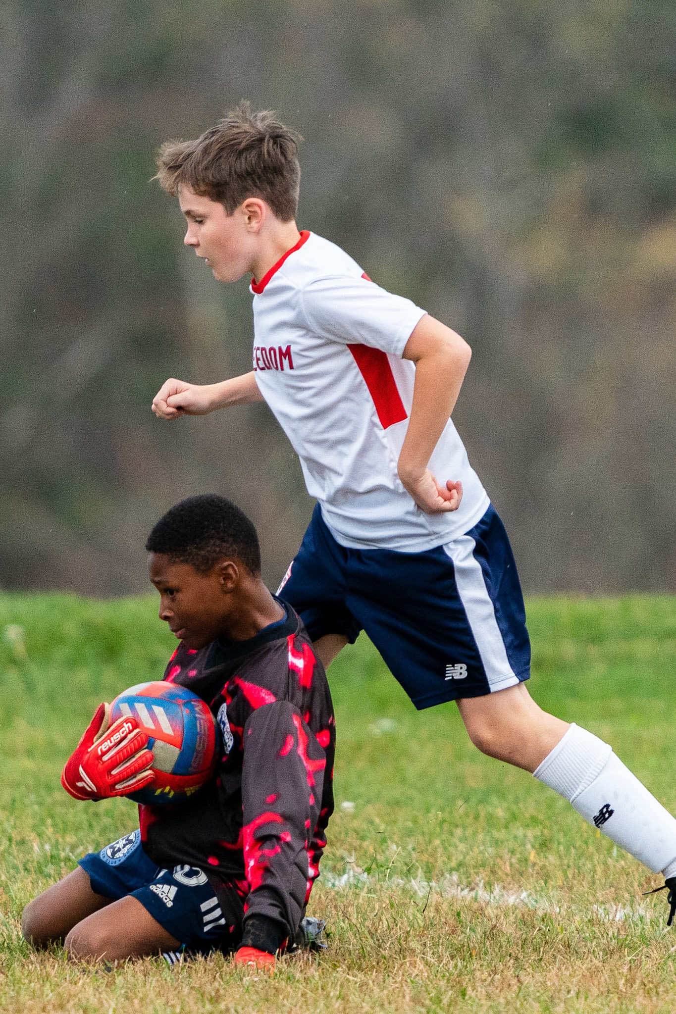 Treme protects the ball as a Freedom attacker puts him under pressure as Mt. Washington defeats Freedom SC 2-1 in their final game of fall 2022.