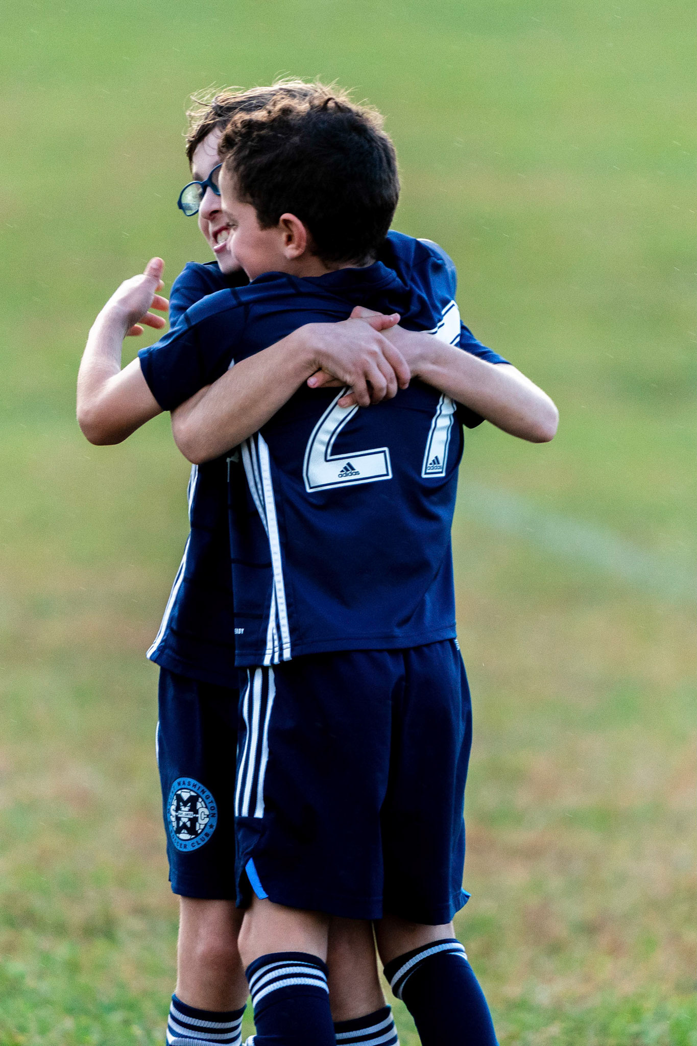 Jonah and Simon embrace at the end of their victory over Freedom SC 2-1.
