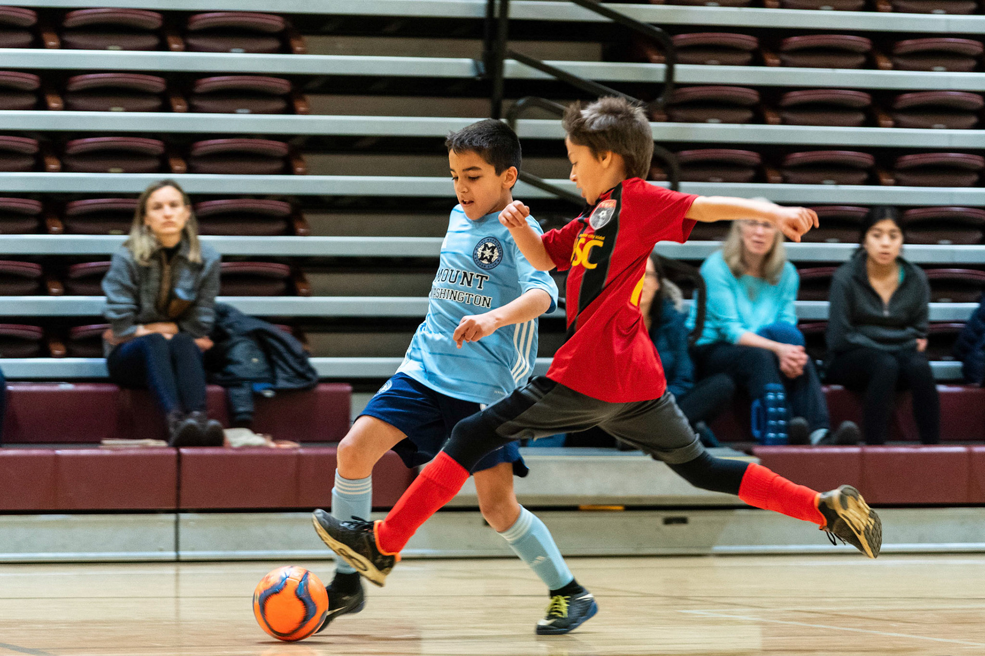 Caleb keeps the ball away from the coming defender as Mt Washington defeats Charles Village Black 11-3 on Saturday, February 18, 2023.