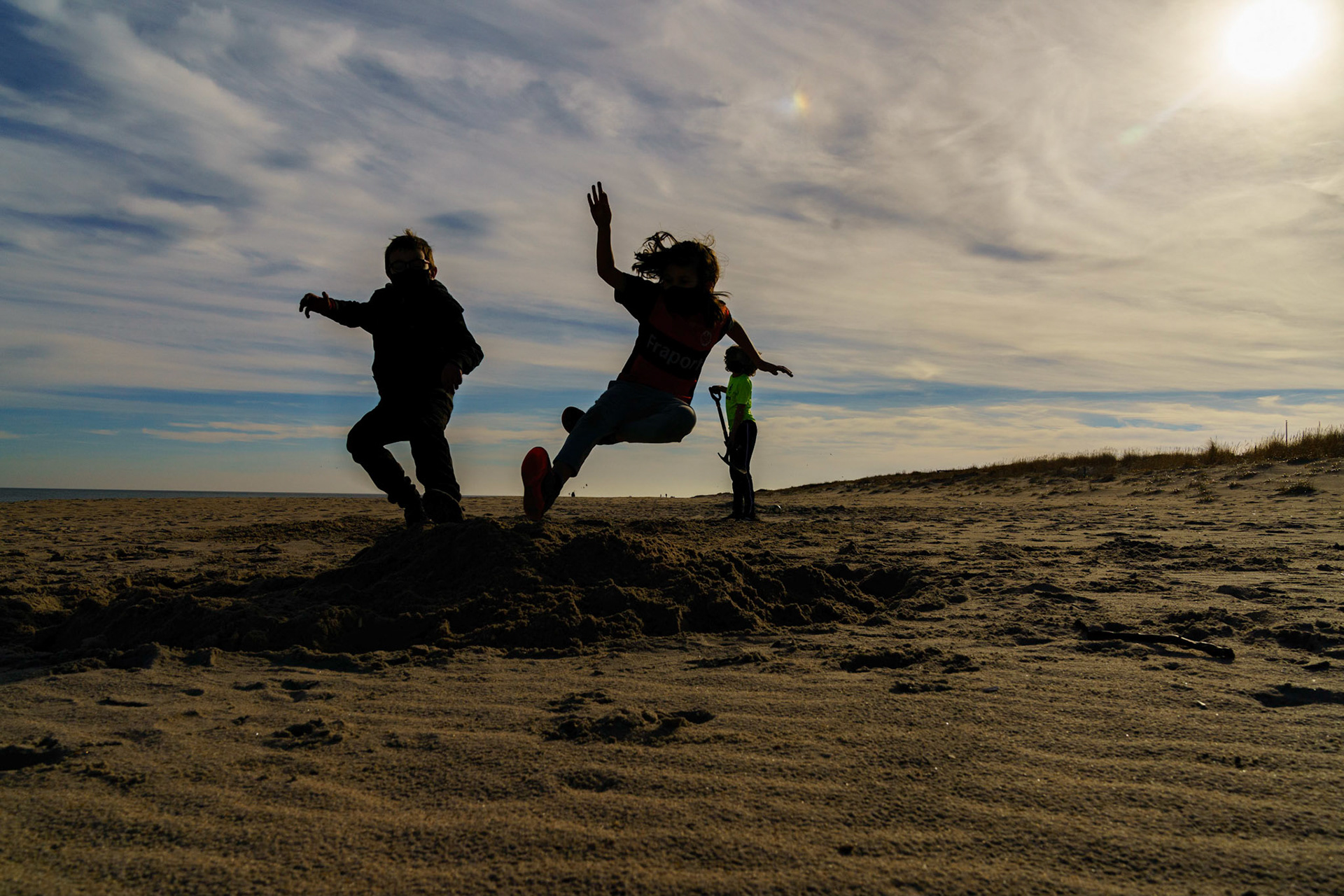 New Year’s trip to the beach. Playing at the beach. Buried little ones.