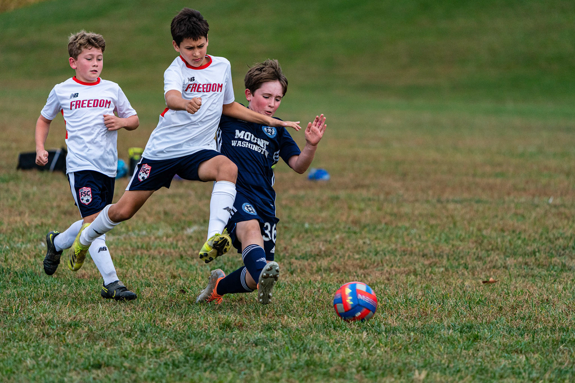 Graham keeps the ball out of reach of the Freedom player as Mt. Washington defeats Freedom SC 2-1 in their final game of fall 2022.