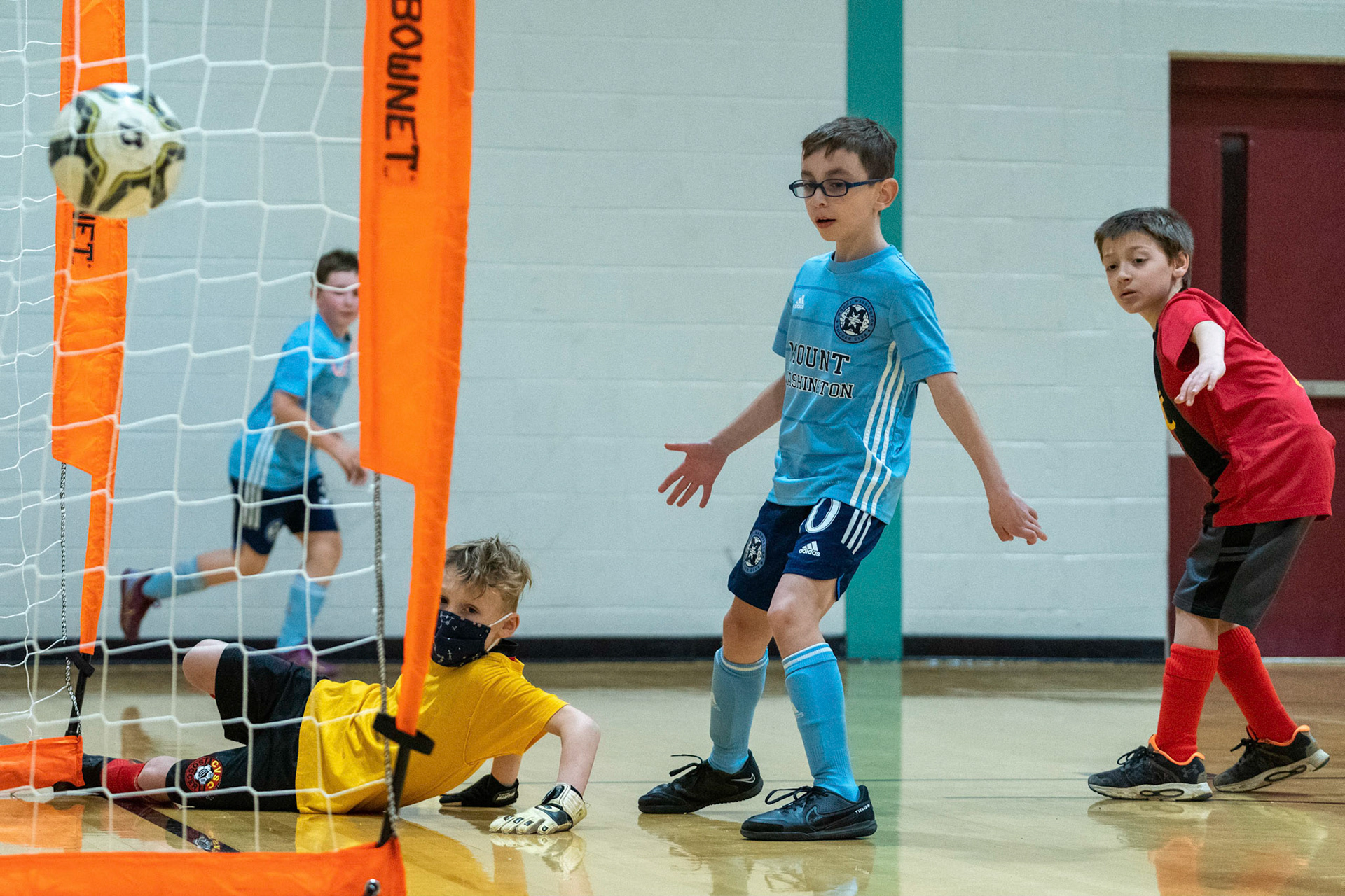 Graham scores on a corner kick as Jonah awaits the rebound in the second half of the Mt. Washington Soccer 22/23 11-3 victory over  Charles Village.