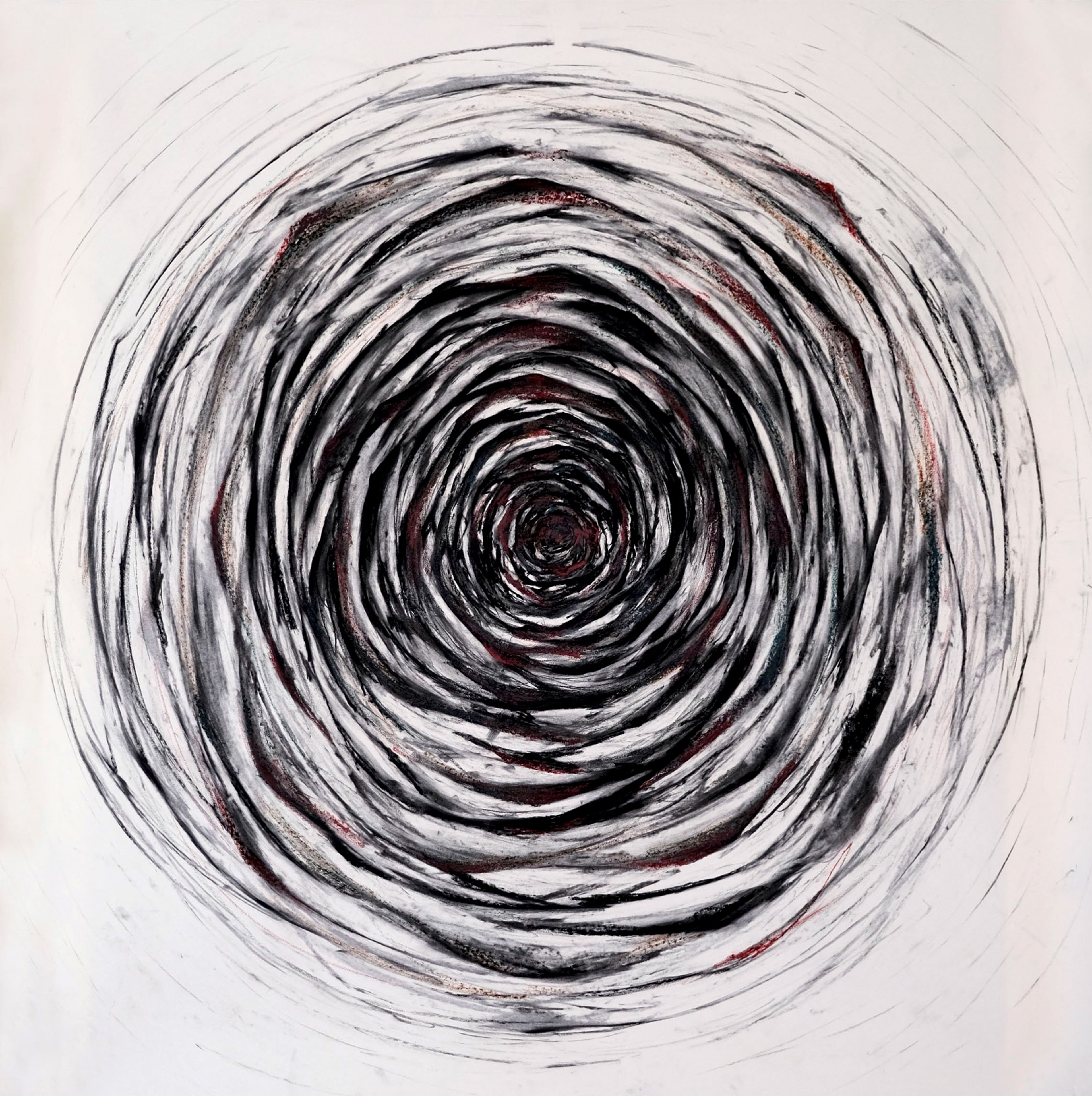 Drawing of dense and imperfect concentric circles in black and red colors on a cream-colored background