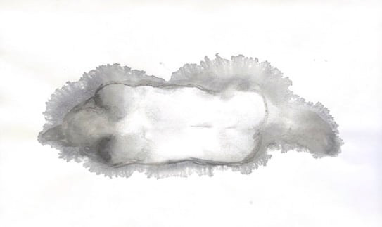 Simple black and white image of a nude person from behind laying on the ground.