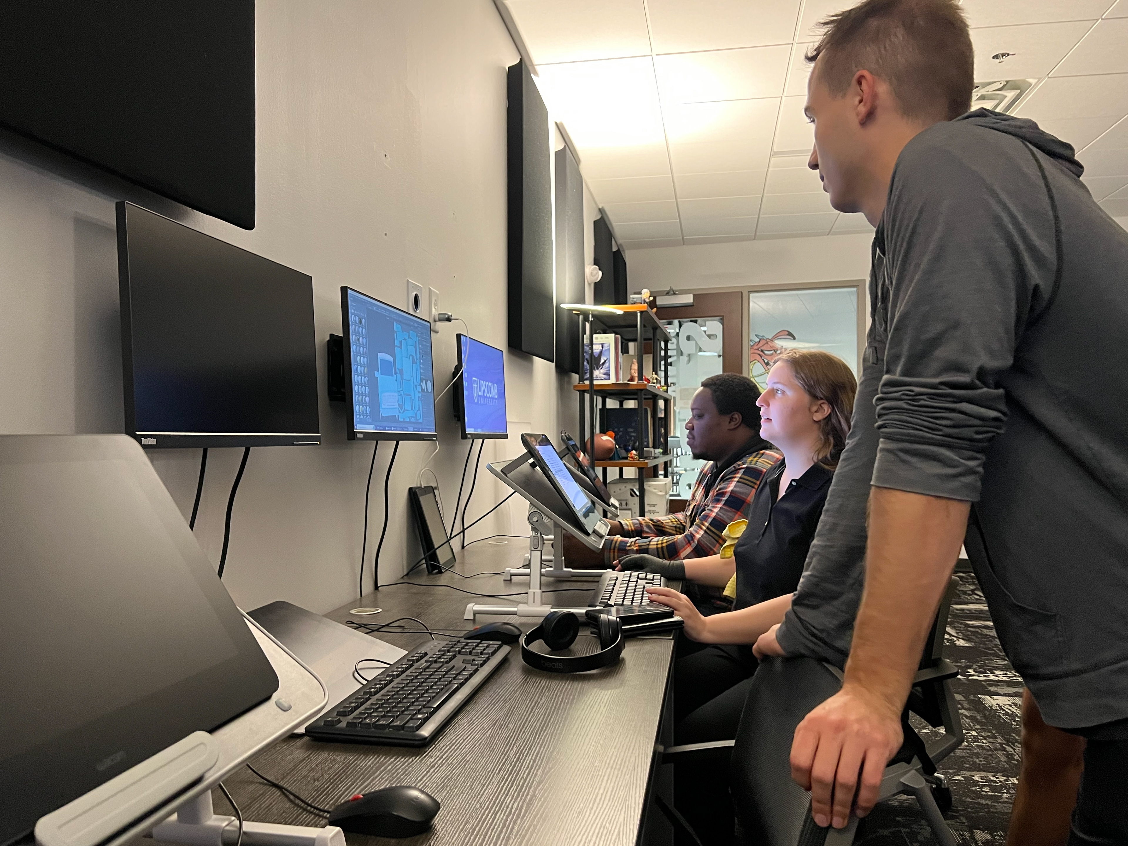 Producer, Michael Stephens, meets with team over model textures.