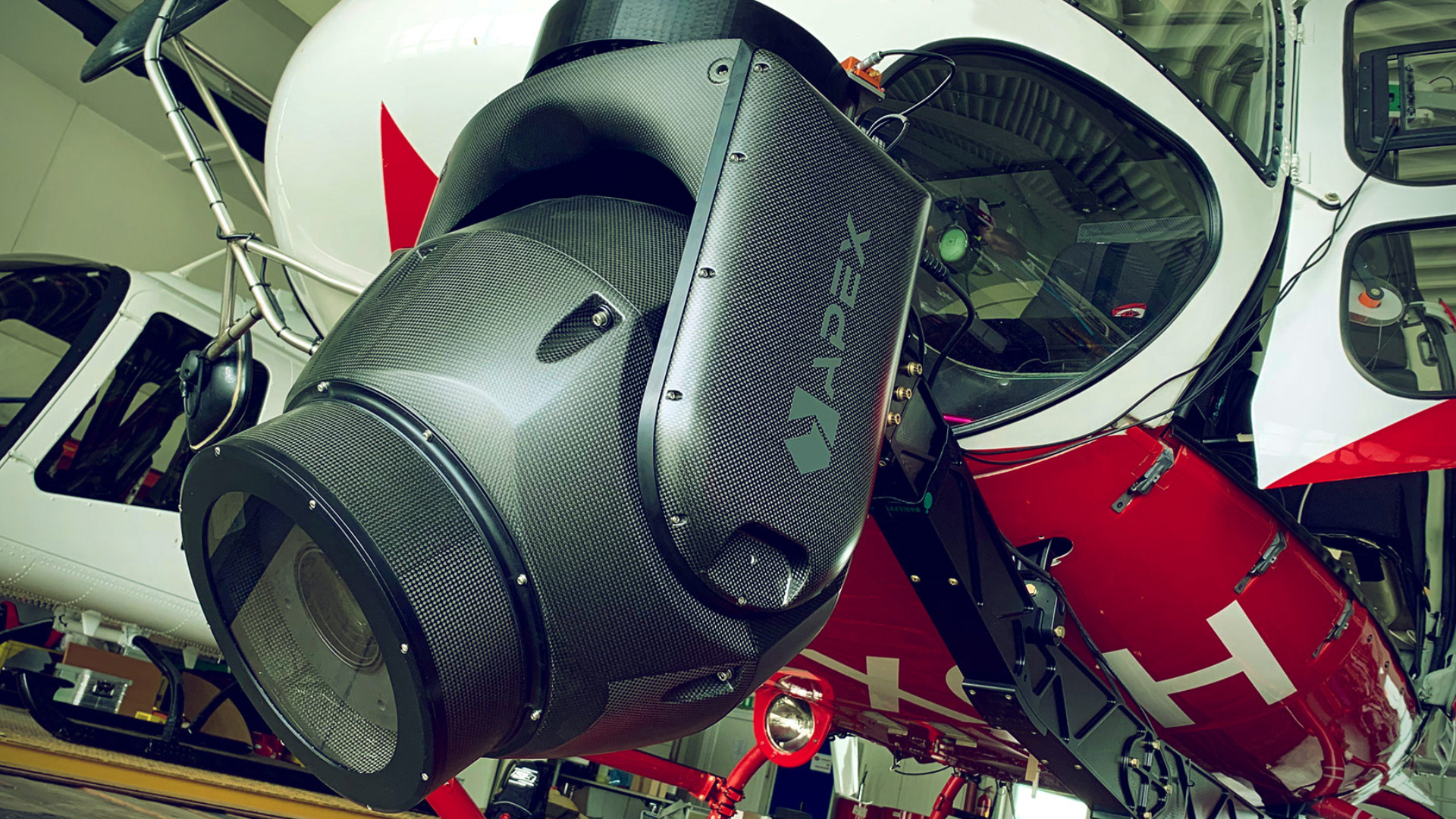 The AX18 stabilized camera gimbal on a AS350 Helicopter