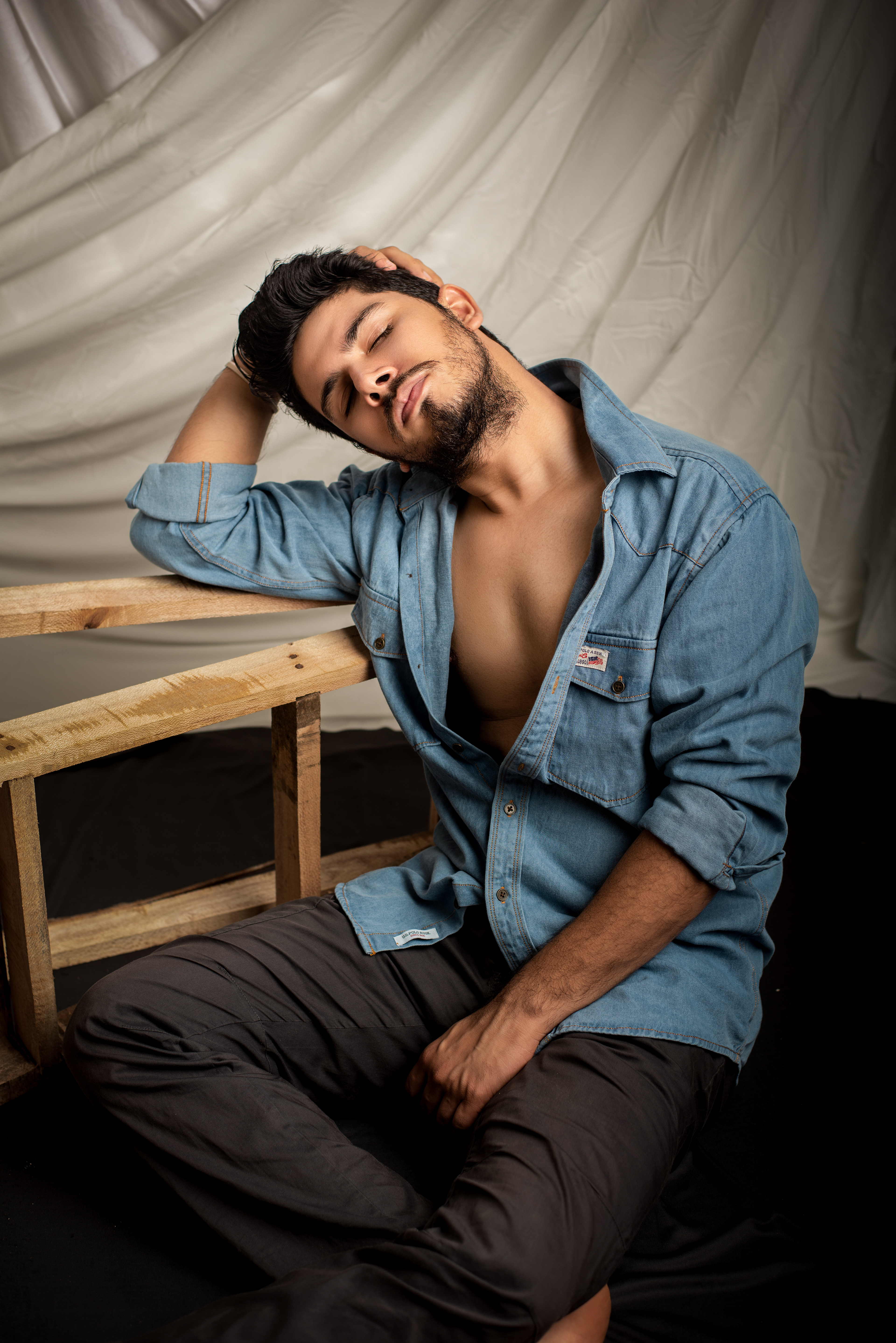 High-fashion portrait with dramatic shadows and sleek styling In Argho Photography Studio