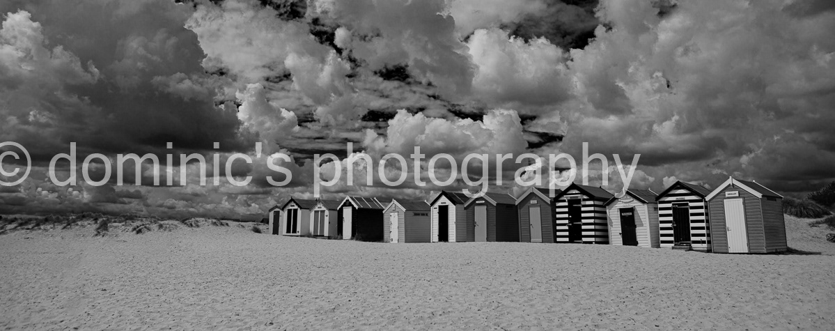 beach huts sky bw