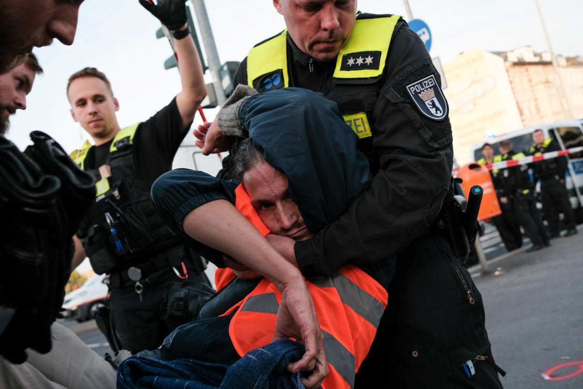 Raúl Semmler is removed from a roadblock by police
