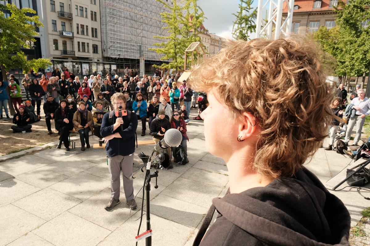 Isi addresses activists in the hours before 350 activists block a major intersection in Berlin.
