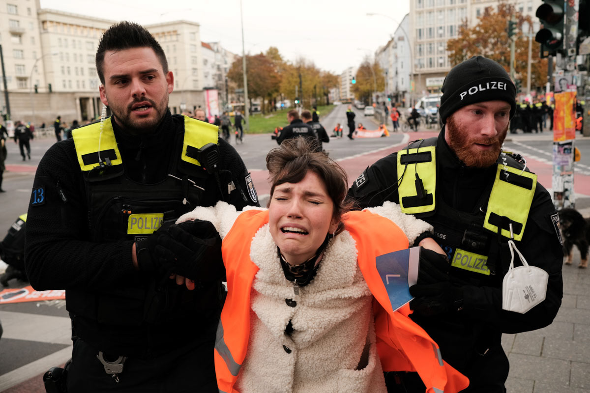Carla Hinrichs is removed from a roadblock by police