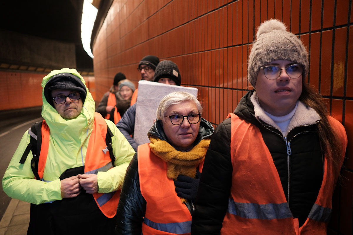 Activists wait for the lights to change before they bvegin their roadblock