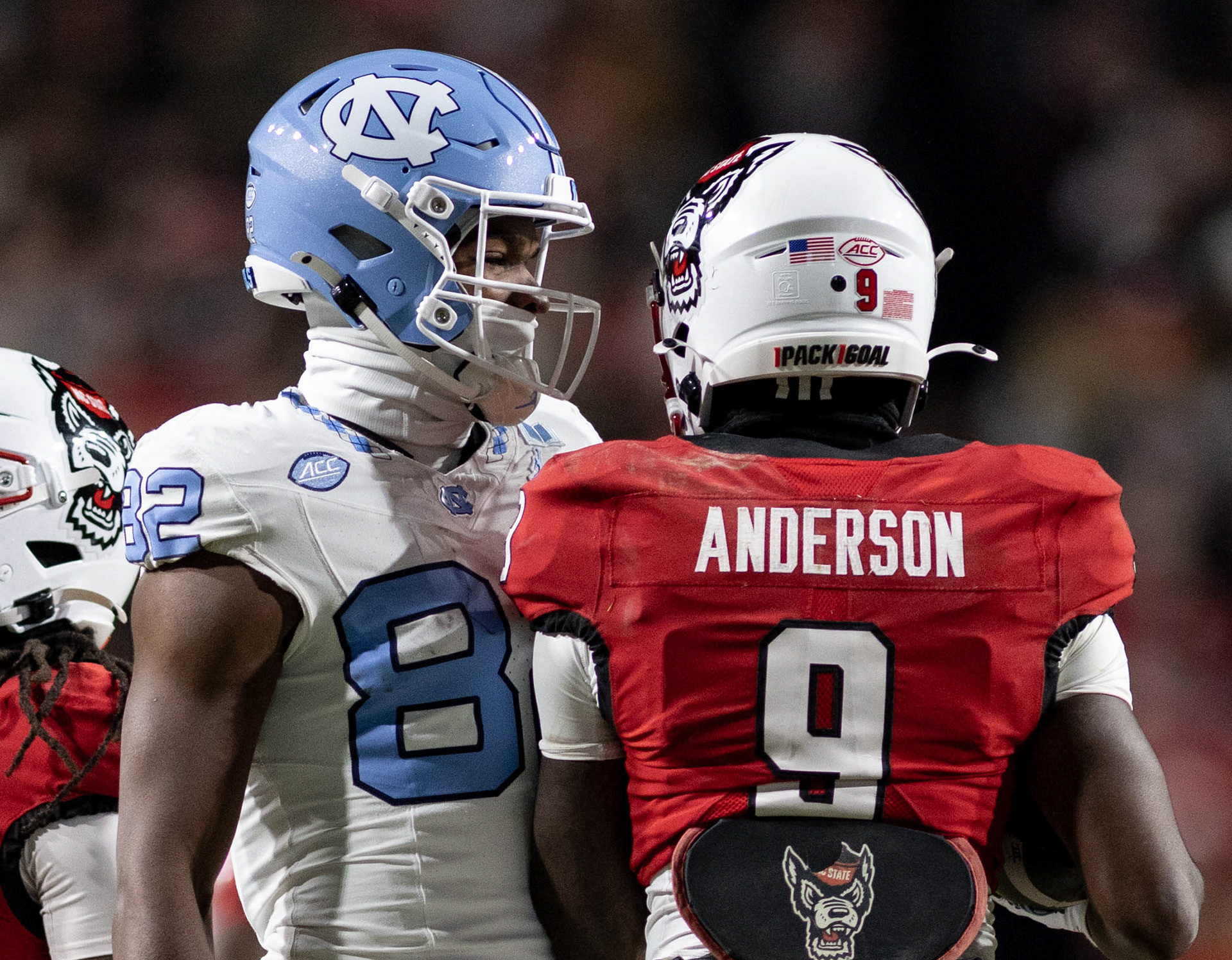 UNC first-year tight end Yasir Smith (82) talks with N.C. State sophomore wide receiver Terrell Anderson during the football game against N.C. State at Carter-Finley Stadium on Saturday, Nov. 29, 2025. UNC lost 42-19.