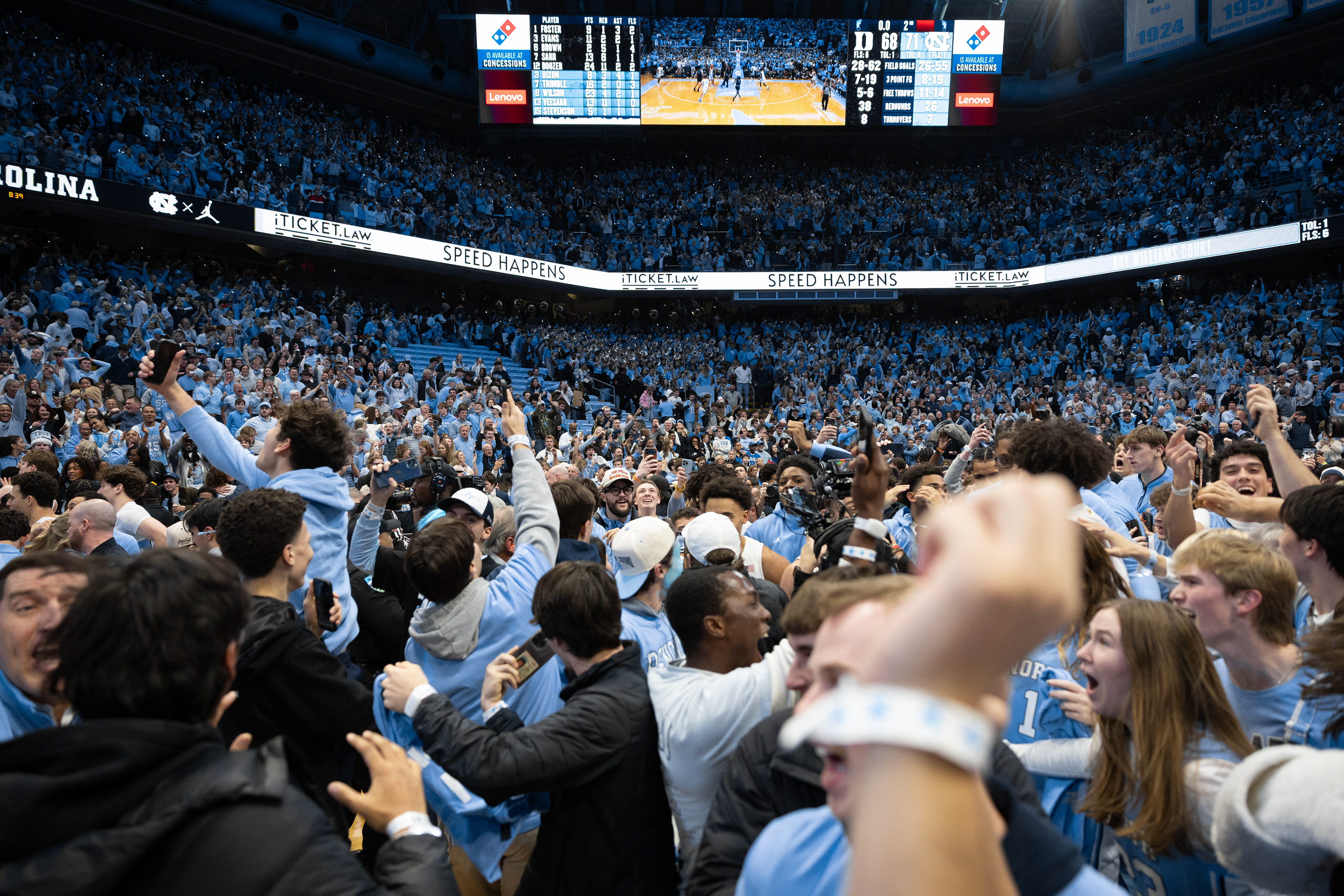 CHAPEL HILL, N.C. — Fans rush the court after UNC's win against Duke during the men's basketball game on Feb. 7, 2026 at the Dean E. Smith Center. The win resulted from a buzzer-beater 3-pointer from guard Seth Trimble.