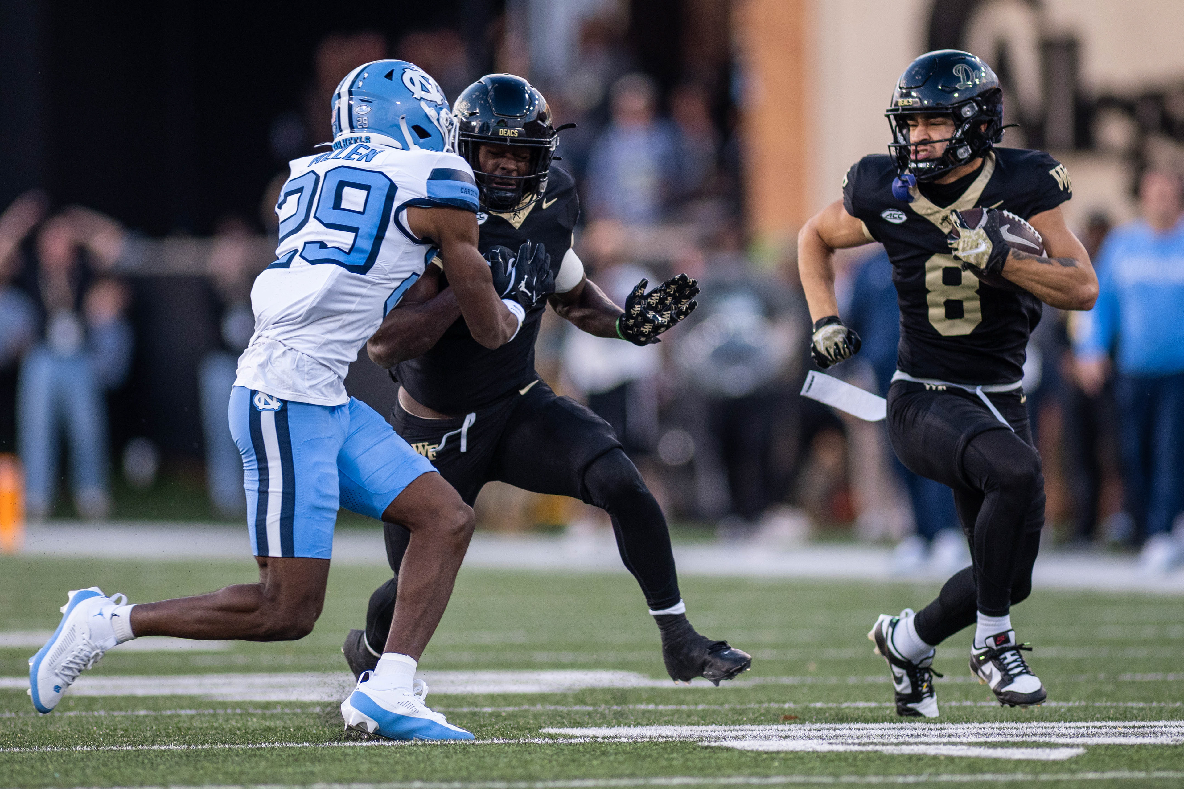 Wake Forest junior wide receiver Carlos Hernandez (8) runs with the ball during the football game against UNC on Saturday, Nov. 15, 2025 at Allegacy Federal Credit Union Stadium.