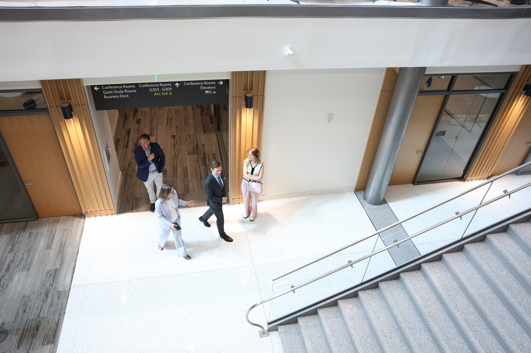 UNC Chancellor Lee Roberts walks with Kenan-Flager Dean Mary Margaret Frank, Senior Director of UNC Media Relations Kevin Best, and Communications Specialist Anna Lutze during a tour of Bell Hall on Wednesday, March 4, 2026. Frank led the tour, which explored the majority of the new business hall.