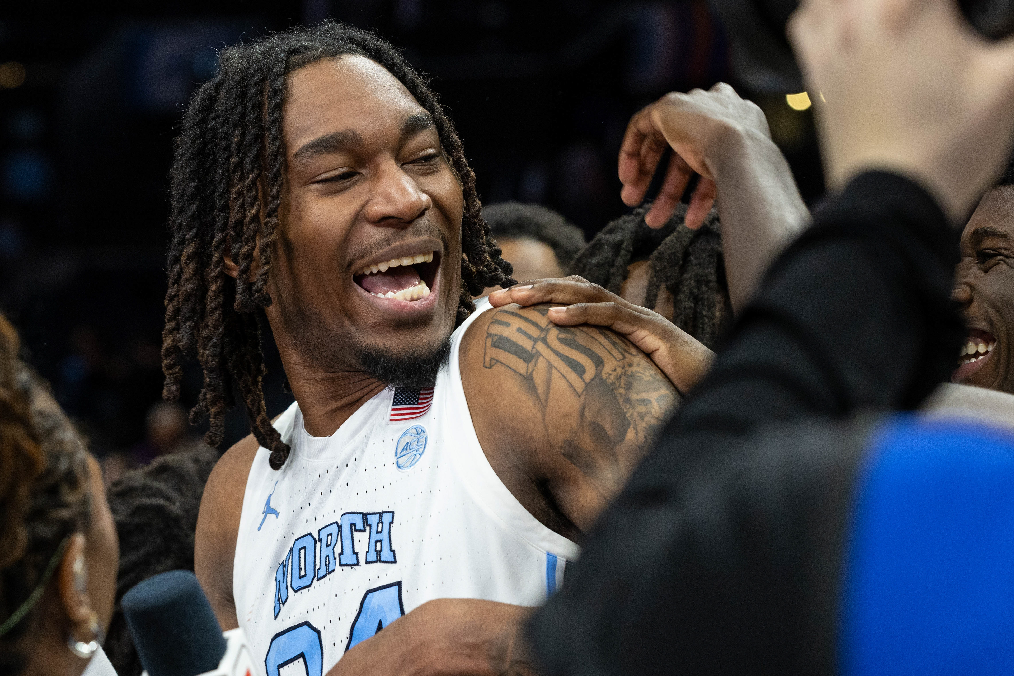 UNC graduate-student forward Jae’Lyn Withers (24) celebrates with his teammates during a post-game interview after the men’s basketball game against Notre Dame during the ACC Tournament on Wedneday, March 12, 2025 at the Spectrum Center. UNC won 76-56.
