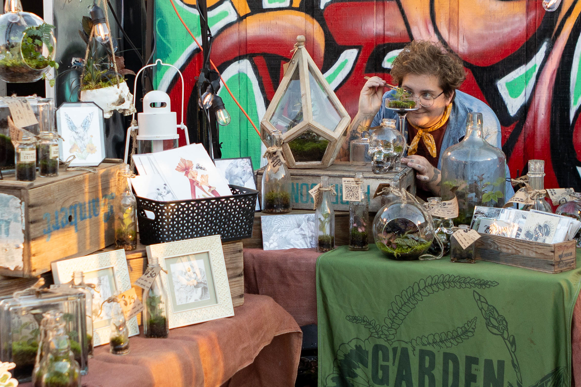 Izzy Hall poses for a portrait at their booth at the Attic 506 rooftop market on Friday, Oct. 11, 2024.