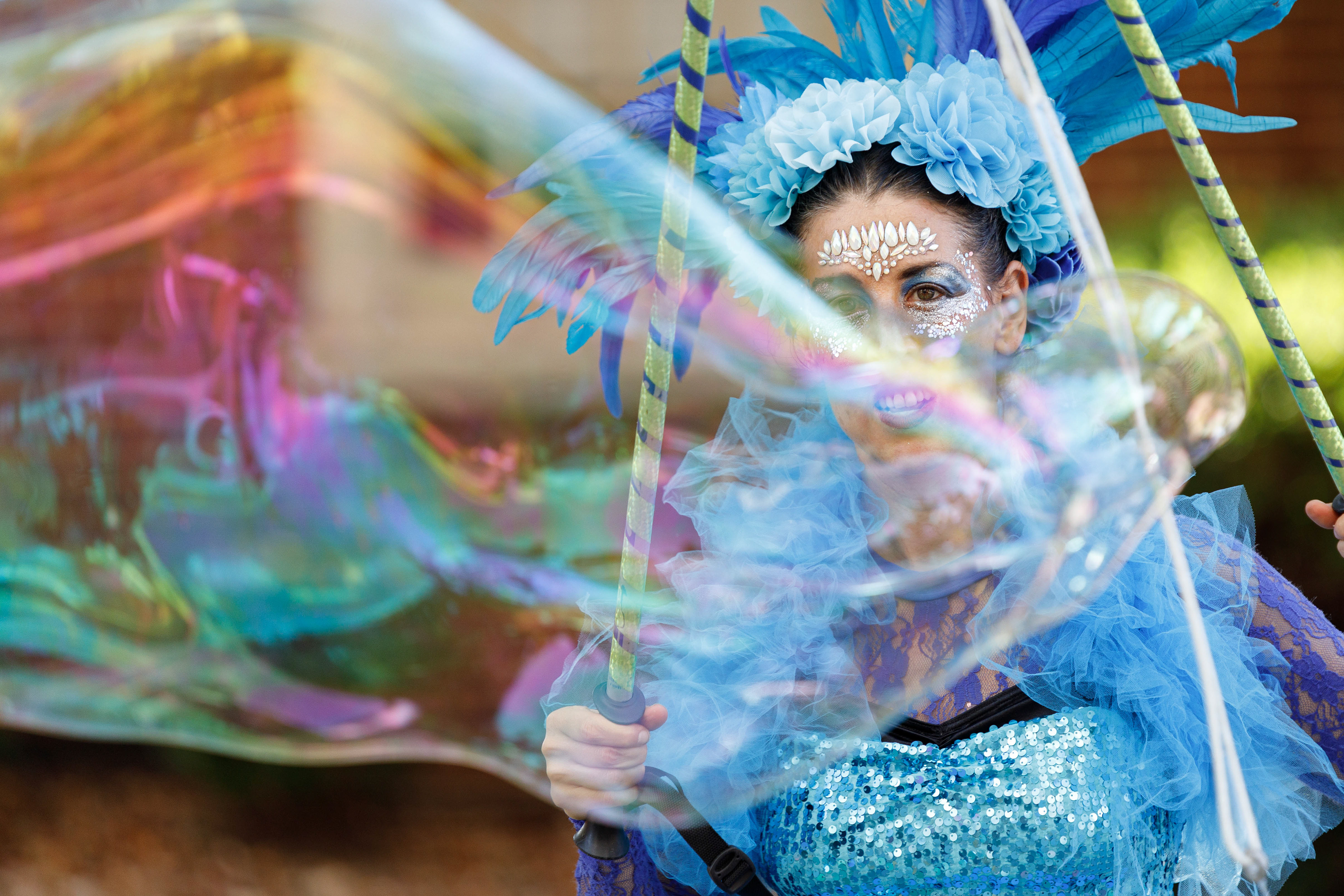 Liz Bliss entertains an audience with large bubbles at the Festifall Arts Market on Franklin Street in Chapel Hill on Saturday, Oct. 26, 2024.