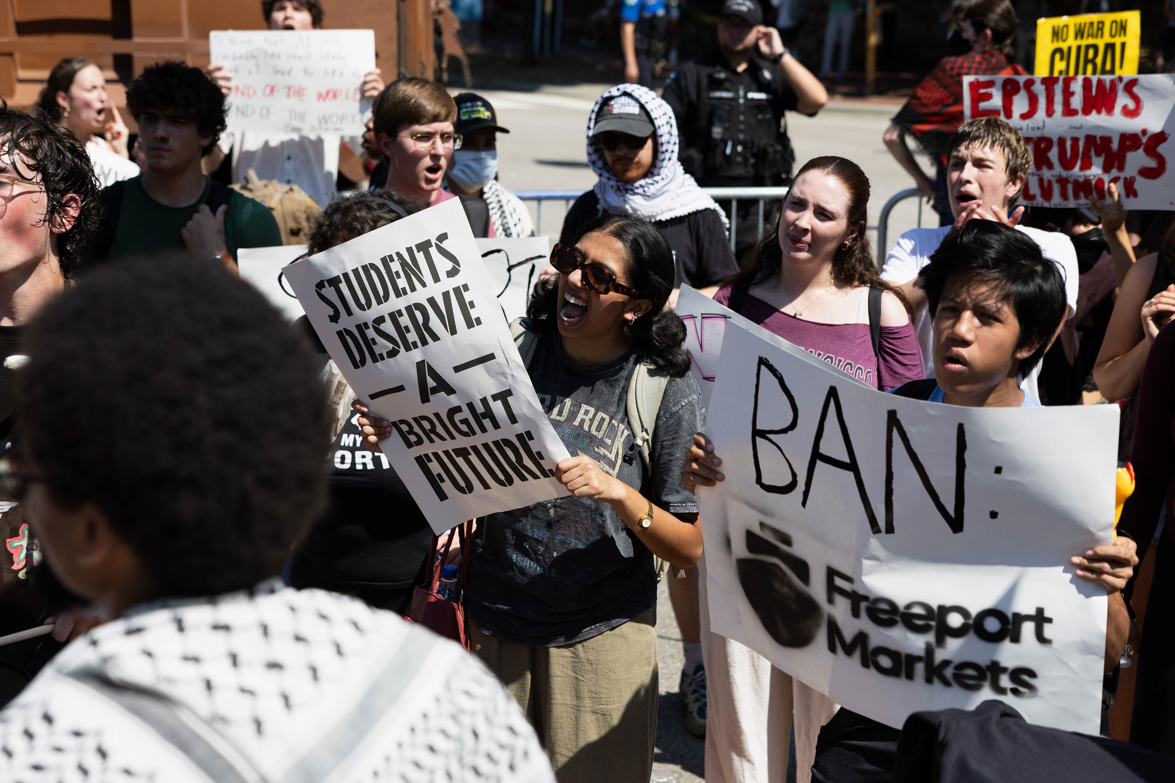 A demonstrator holding a sign that reads "STUDENTS DESERVE A BRIGHT FUTURE" protests outside of the Carolina Inn during the G20 Summit on Wednesday, Sept. 2, 2026.