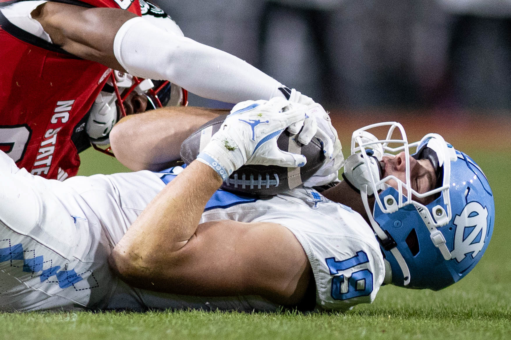 UNC redshirt junior tight end Jake Johnson (19) gets tackled during the football game against N.C. State at Carter-Finley Stadium on Saturday, Nov. 29, 2025. UNC lost 42-19.