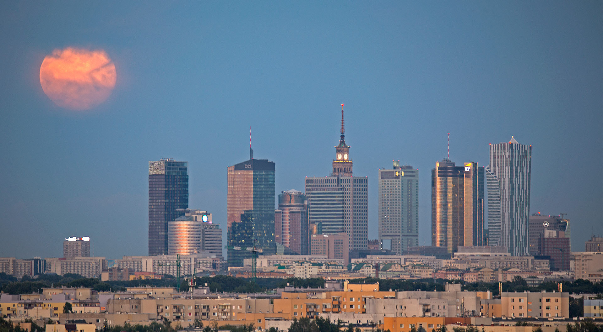 Moon rise with skyscrapers in Warsaw, Poland.
