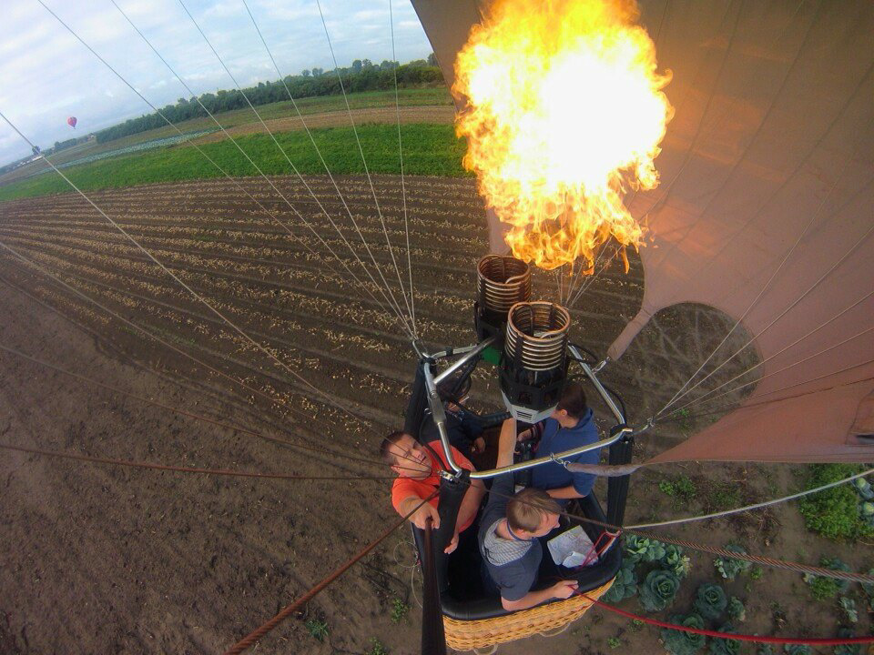 Flying a hot air balloon. Wilanów, Poland.
