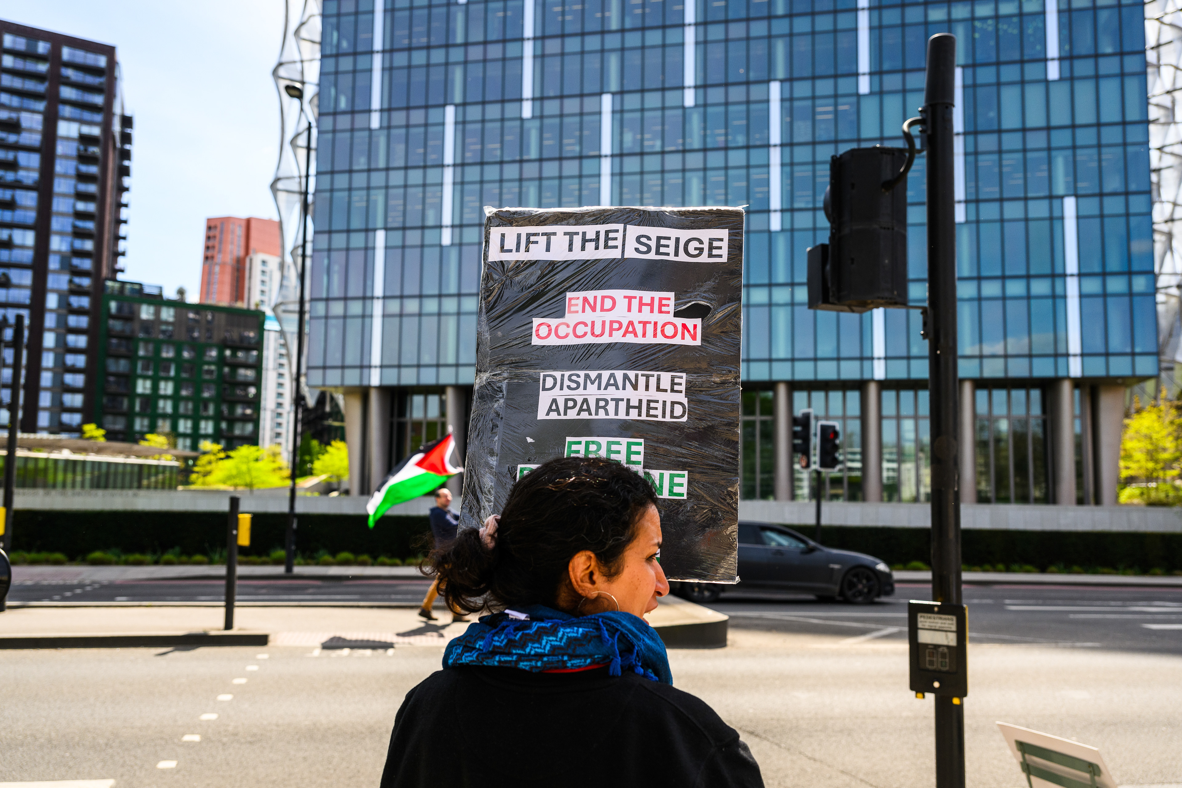 The protesters stand by the roadside outside the US Embassy to wave the Palestine flag and encourage support from drivers