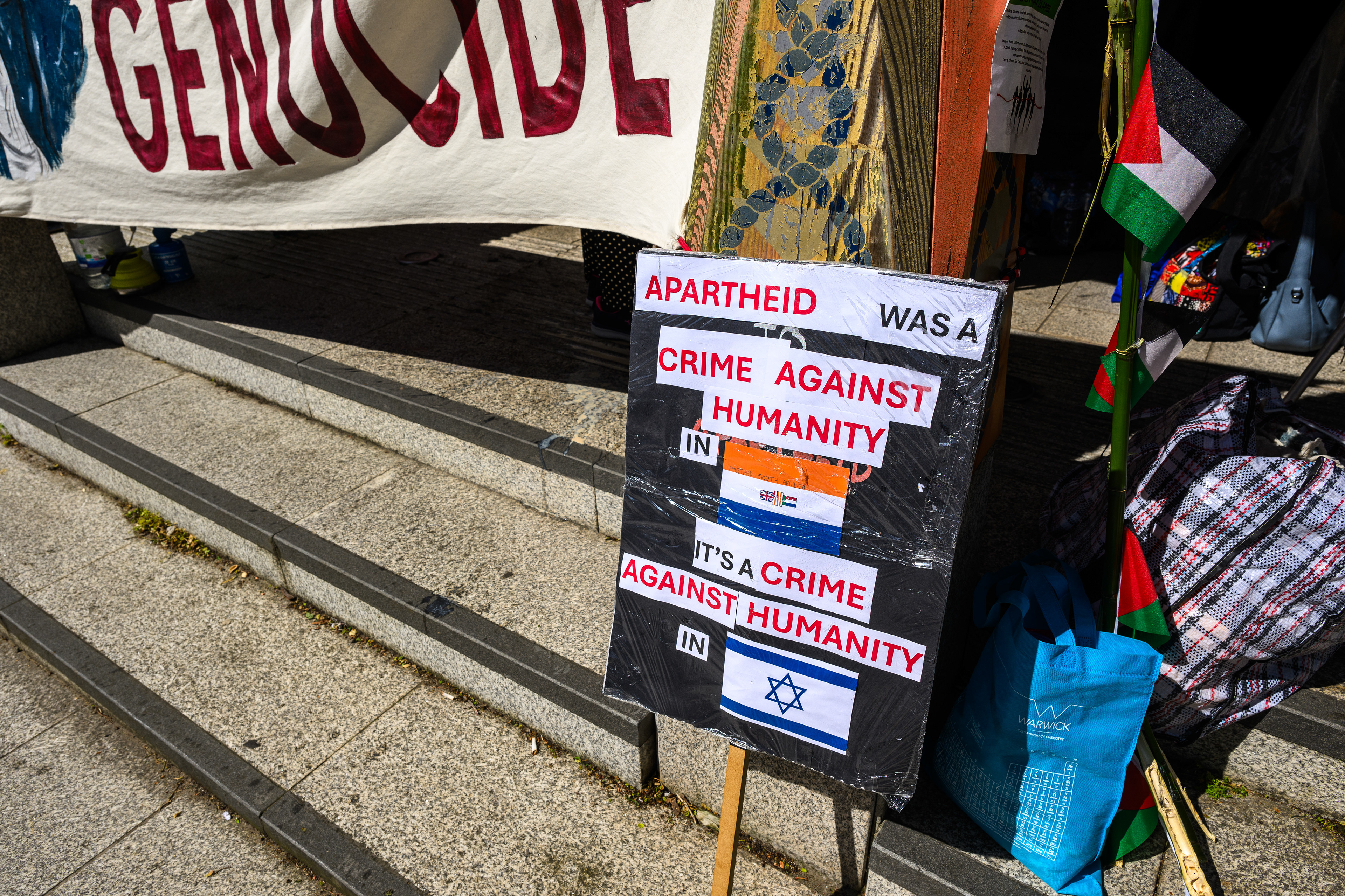 The camp is thick with protest signage and decorations.