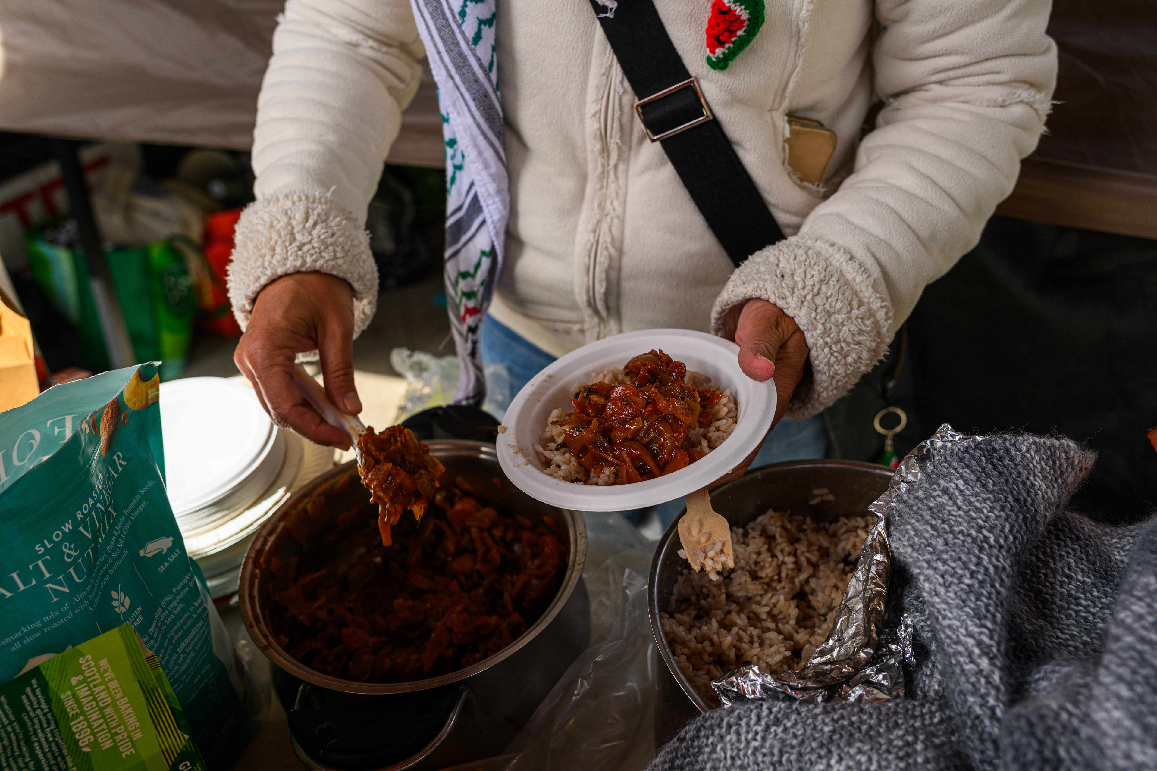 Food is prepared and shared in the communal kitchen at the roadside camp opposite the US Embassy in London.
