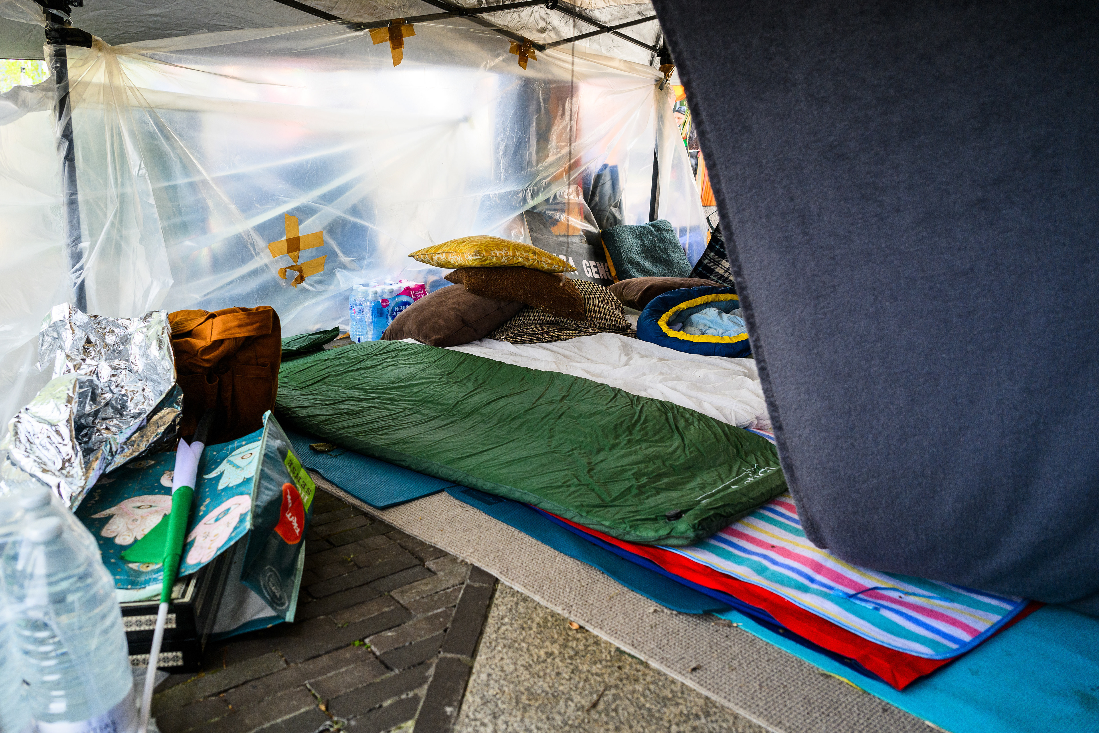 The sleeping area is a tent with some floors mats and sleeping bags. Protesters stay here at night to keep the camp safe outside the US Embassy