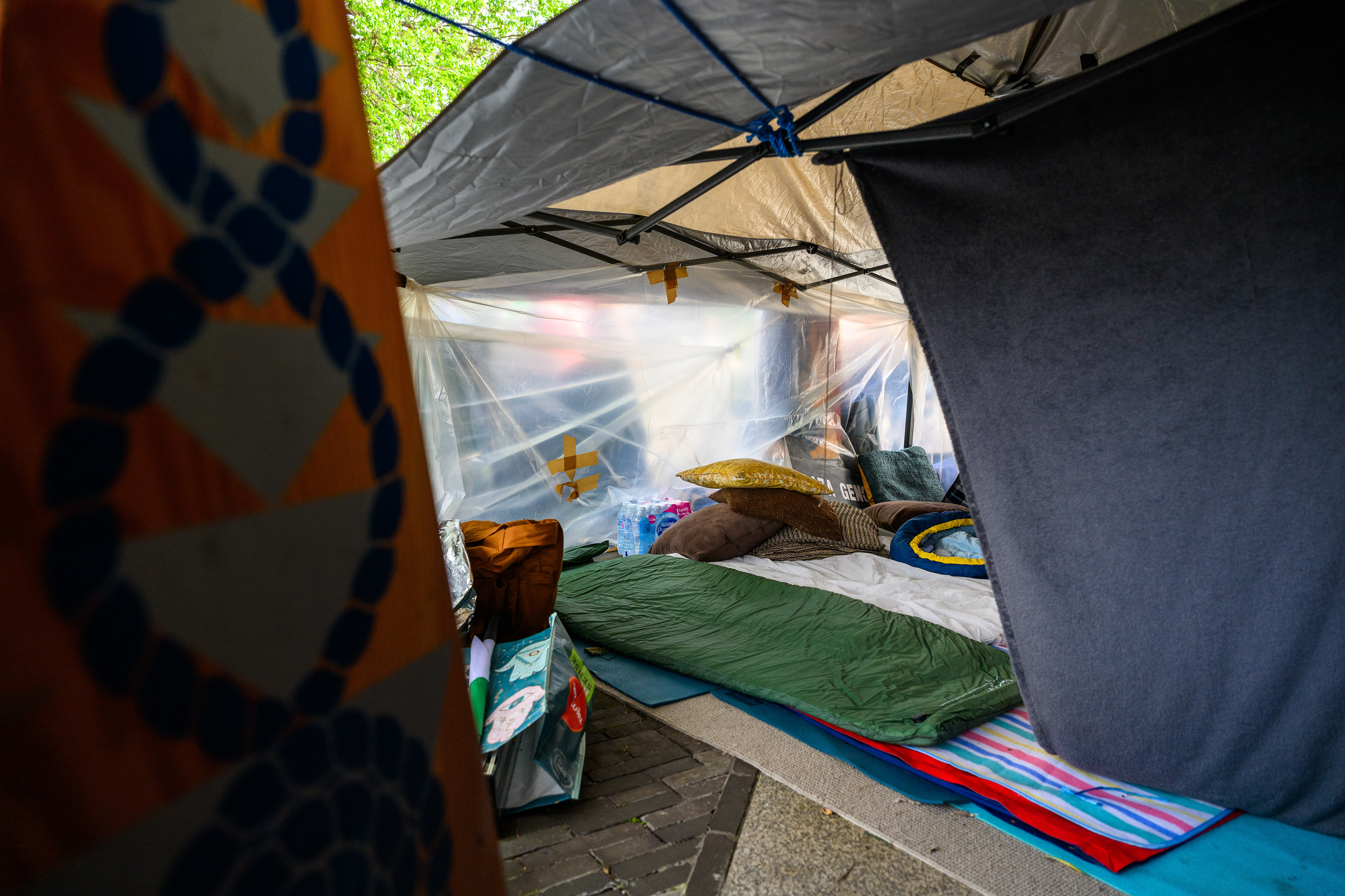 The sleeping area is a tent with some floors mats and sleeping bags. Protesters stay here at night to keep the camp safe outside the US Embassy