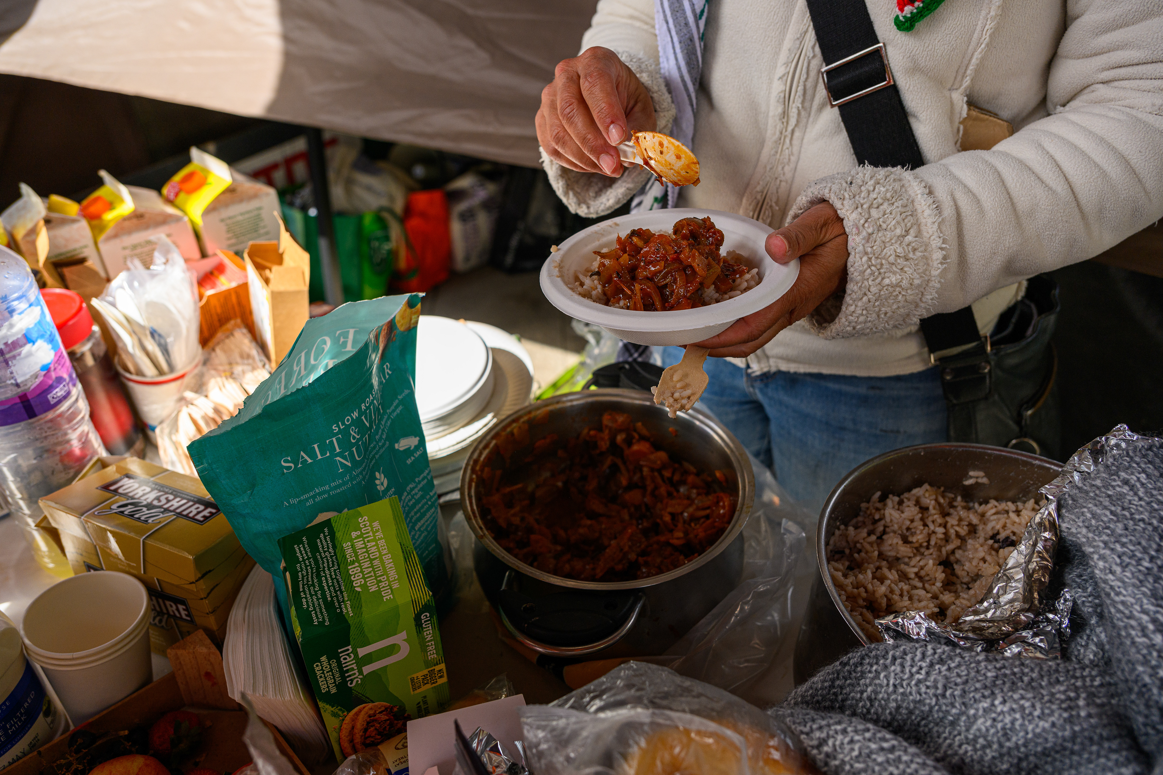 Food is prepared and shared in the communal kitchen at the roadside camp opposite the US Embassy in London.
