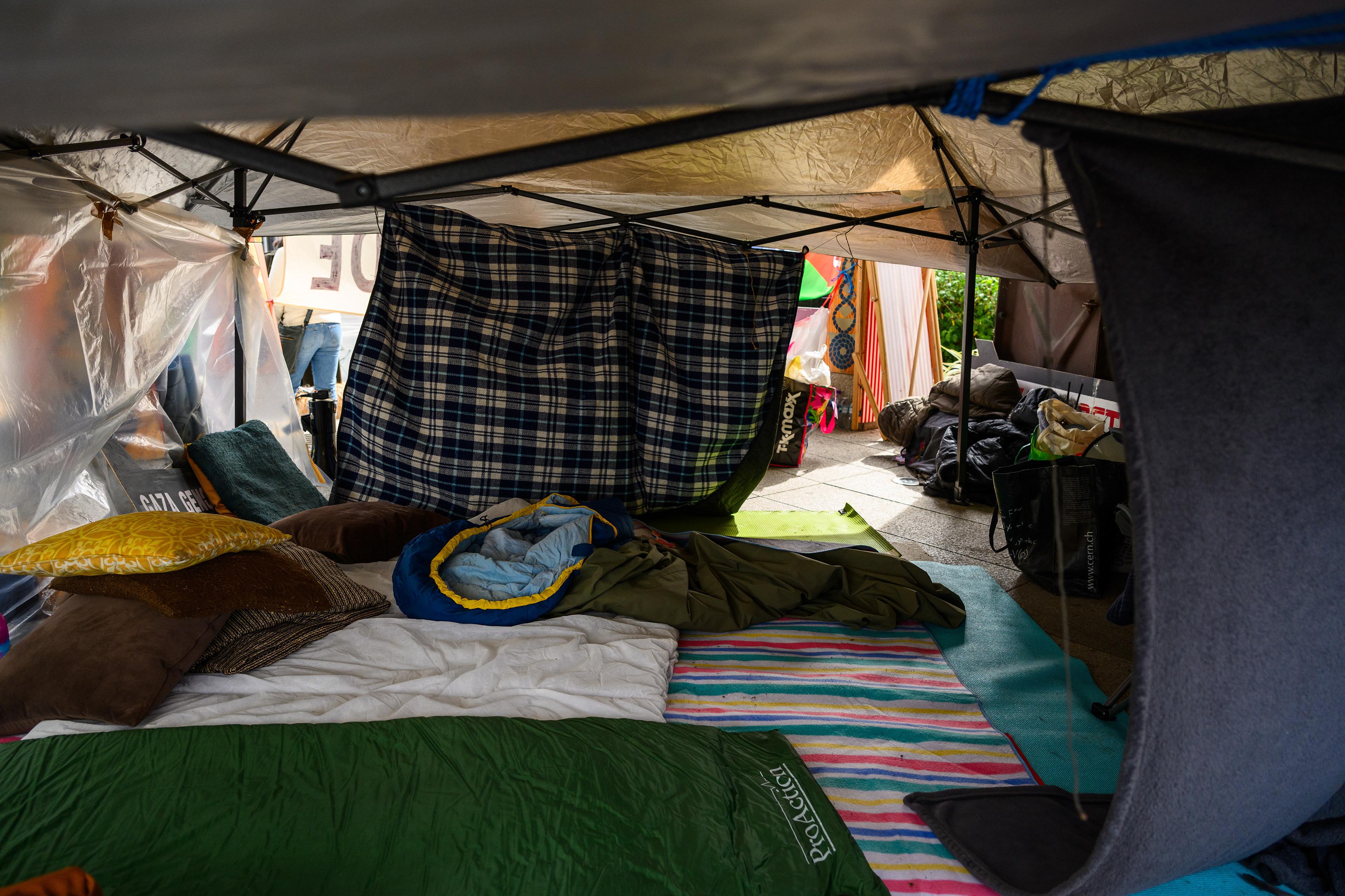 The sleeping area is a tent with some floors mats and sleeping bags. Protesters stay here at night to keep the camp safe outside the US Embassy